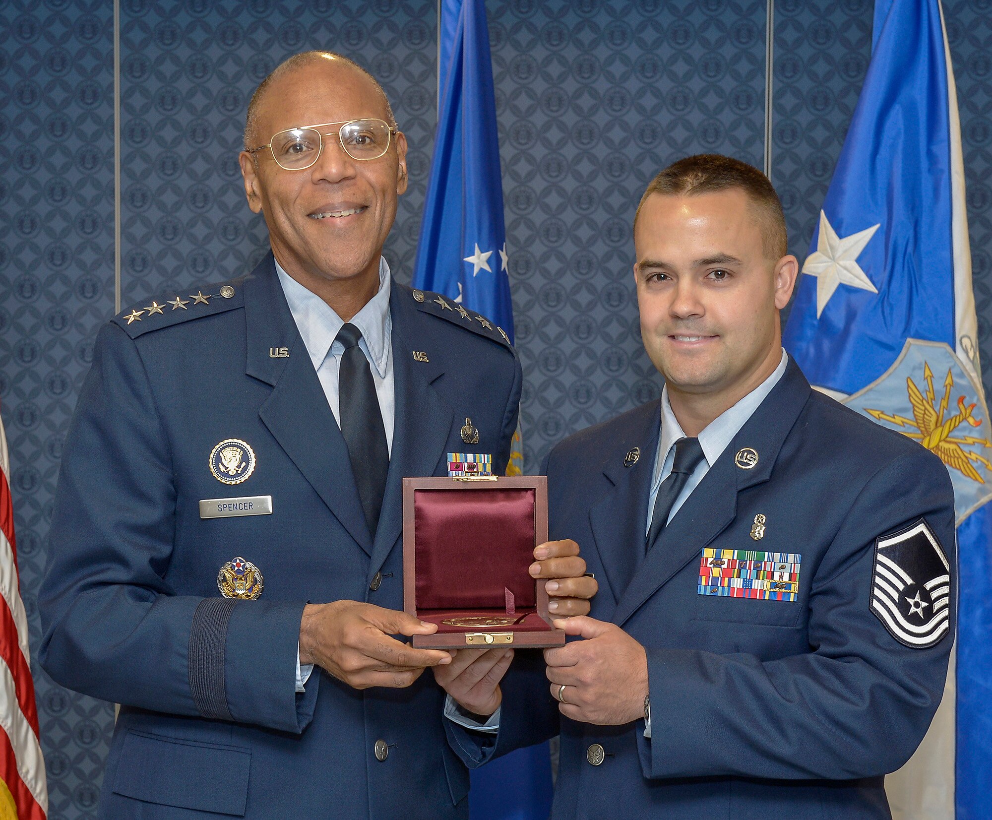 Air Force Vice Chief of Staff Gen. Larry Spencer presents the 2011 Cheney Award to Master Sgt. Joseph Brownell during a ceremony at the Pentagon on Nov. 1, 2012. Brownell earned the award for a harrowing rescue mission to extract a medically distressed civilian hiker and his son from the Cascade Mountains of Washington state. (U.S. Air Force photo/Michael J. Pausic)