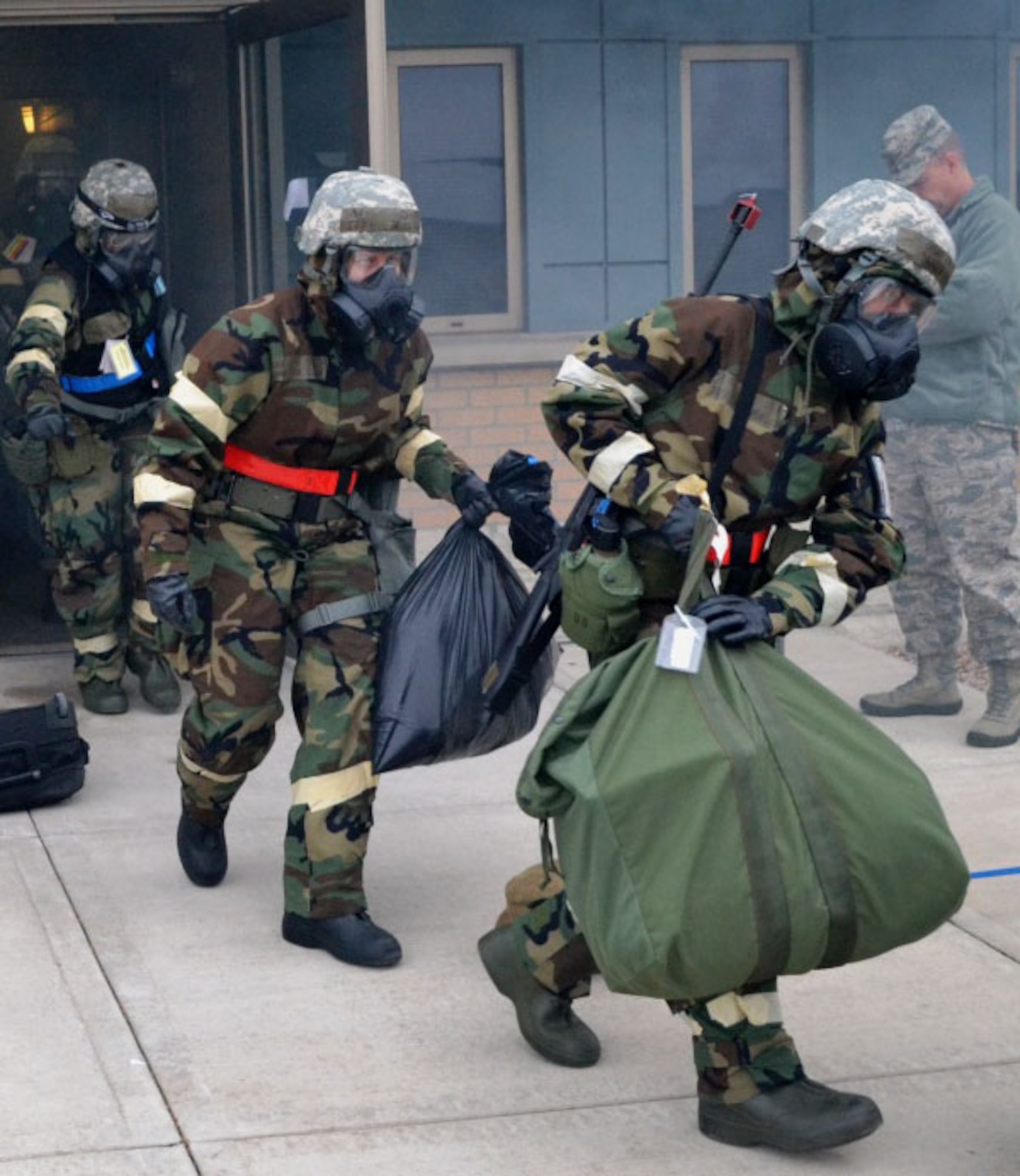 An inspector grades Reservists from the 446th Airlift Wing as they initiate “bug out” procedures during an Operational Readiness Inspection scenario at Volk Field Combat Readiness Training Center, Wis. Oct. 18.  The 446th AW teamed up with its active-duty brothers and sisters from the 62nd Airlift Wing and 627th Air Base Group for the inspection.  (Courtesy photo)