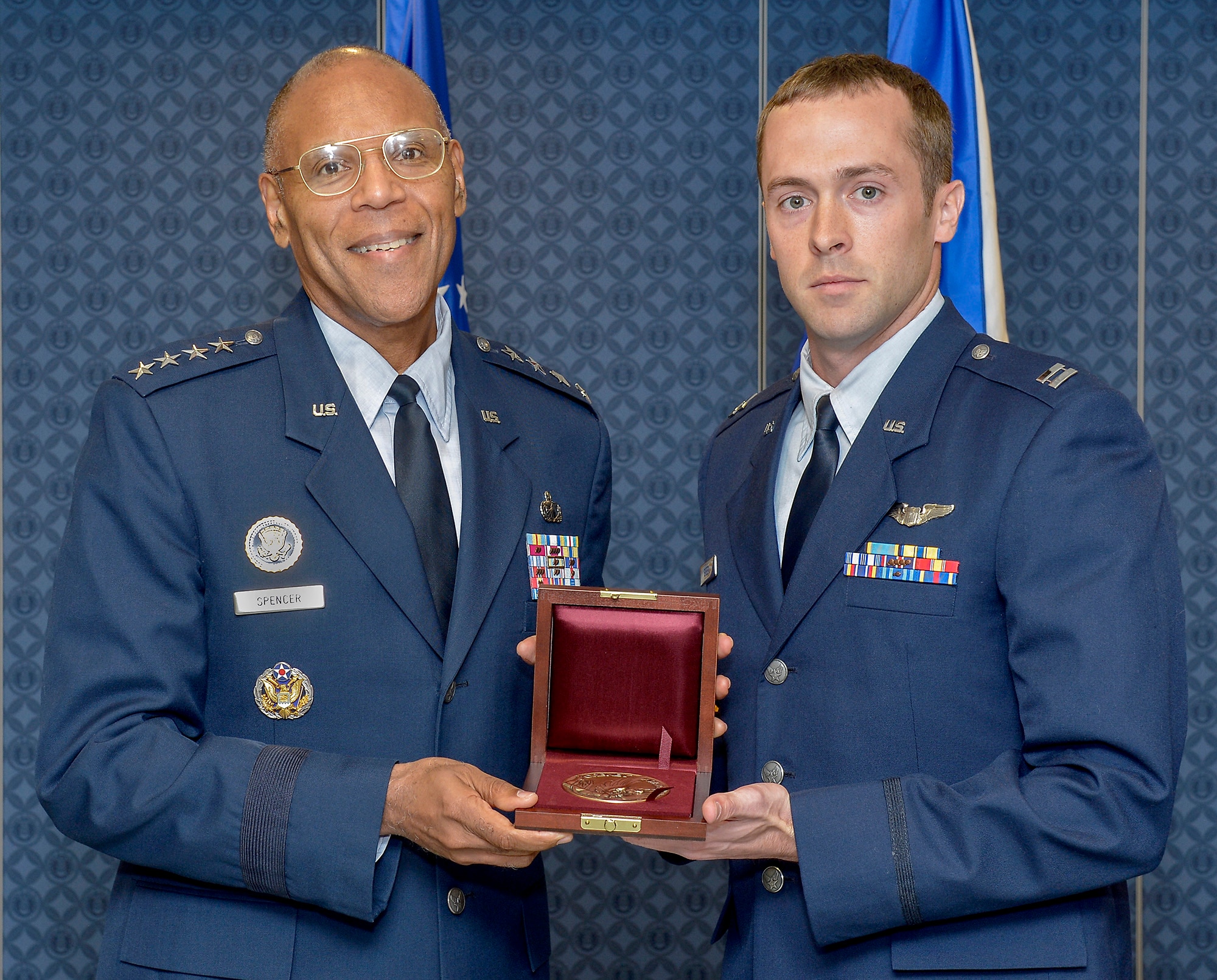 Air Force Vice Chief of Staff Gen. Larry Spencer presents the 2011 Cheney Award to Capt. Kenneth Green during a ceremony at the Pentagon on Nov. 1, 2012. Established in 1927, the Cheney Award is awarded to Airmen for an act of valor, extreme fortitude or self-sacrifice in a humanitarian interest, performed with an aircraft. (U.S. Air Force photo/Michael J. Pausic)