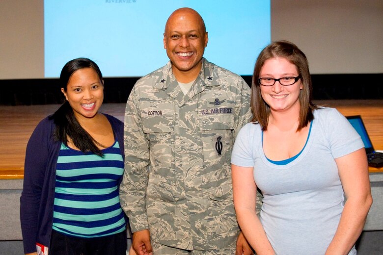 Brig. Gen. Anthony Cotton, 45th Space Wing, commander, poses with Trisha Atkins, wife of Airman 1st Class Erol Atkins, (left) and Melissa Stetler, wife of Airman 1st Class Robert Stetler (right) the winners of the Patrick AFB "Name that Neighborhood" Contest.  Photo by Matthew Jurgens