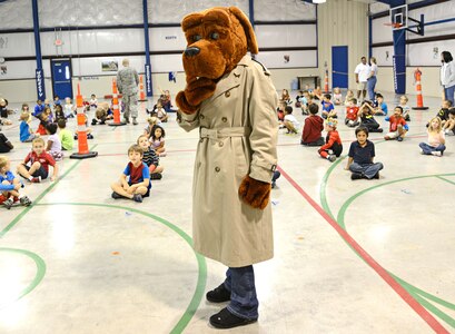 McGruff the Crime Dog, teaches the importance of reporting illegal activity to kindergartners at Randolph Elementary School, Oct. 25 at Joint Base San Antonio-Randolph. McGruff the Crime Dog is a cartoon bloodhound used by the National Crime Prevention Council to spread awareness of crime to children. (U.S. Air Force photo by Benjamin Faske)
