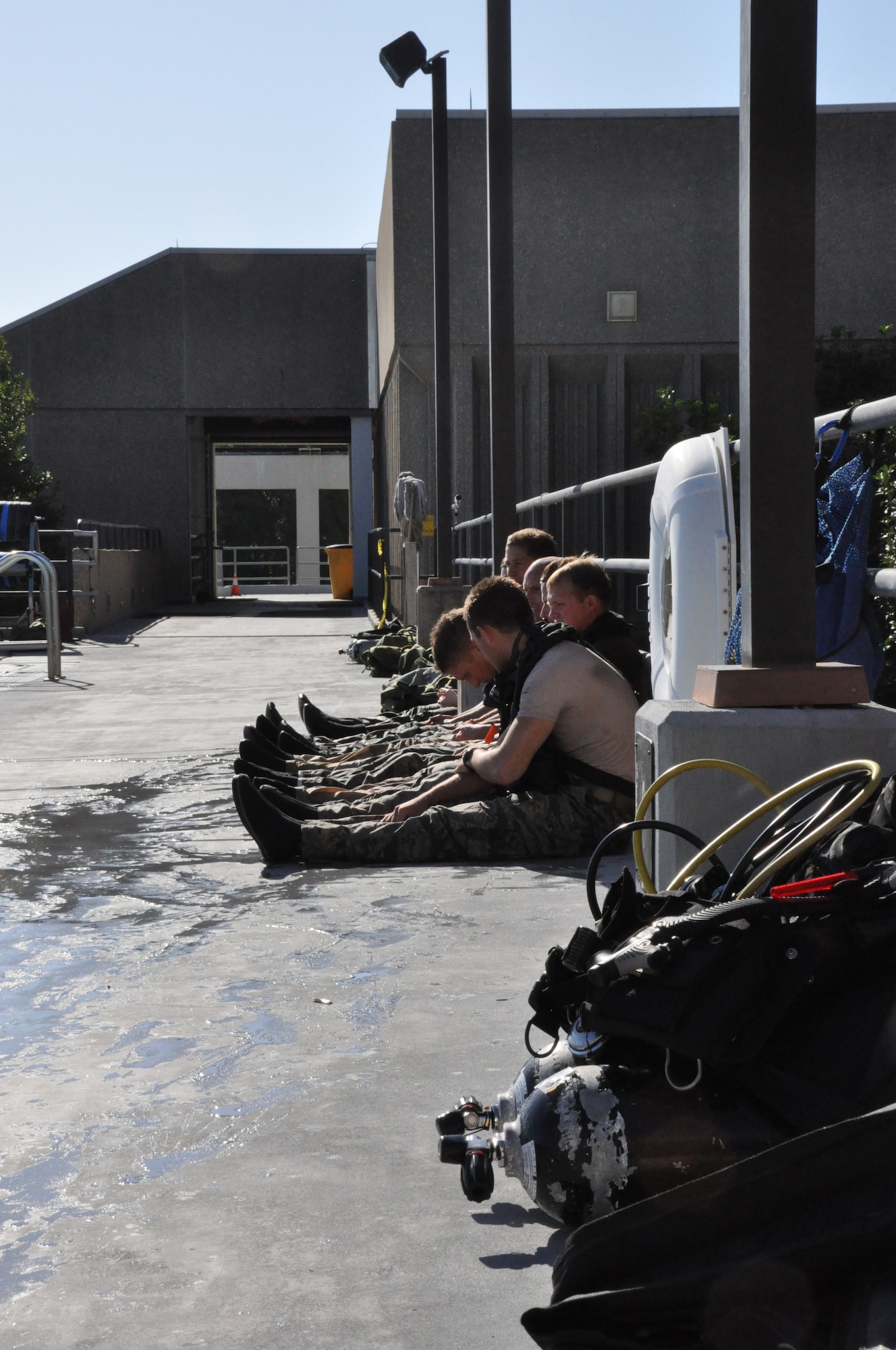 Airmen catch their breath and bring their heart rates down after practicing ascension skills during dive training at the Naval Support Activity Panama City, Oct. 25. (U.S. Air Force photo by Airman 1st Class Christopher Reel)