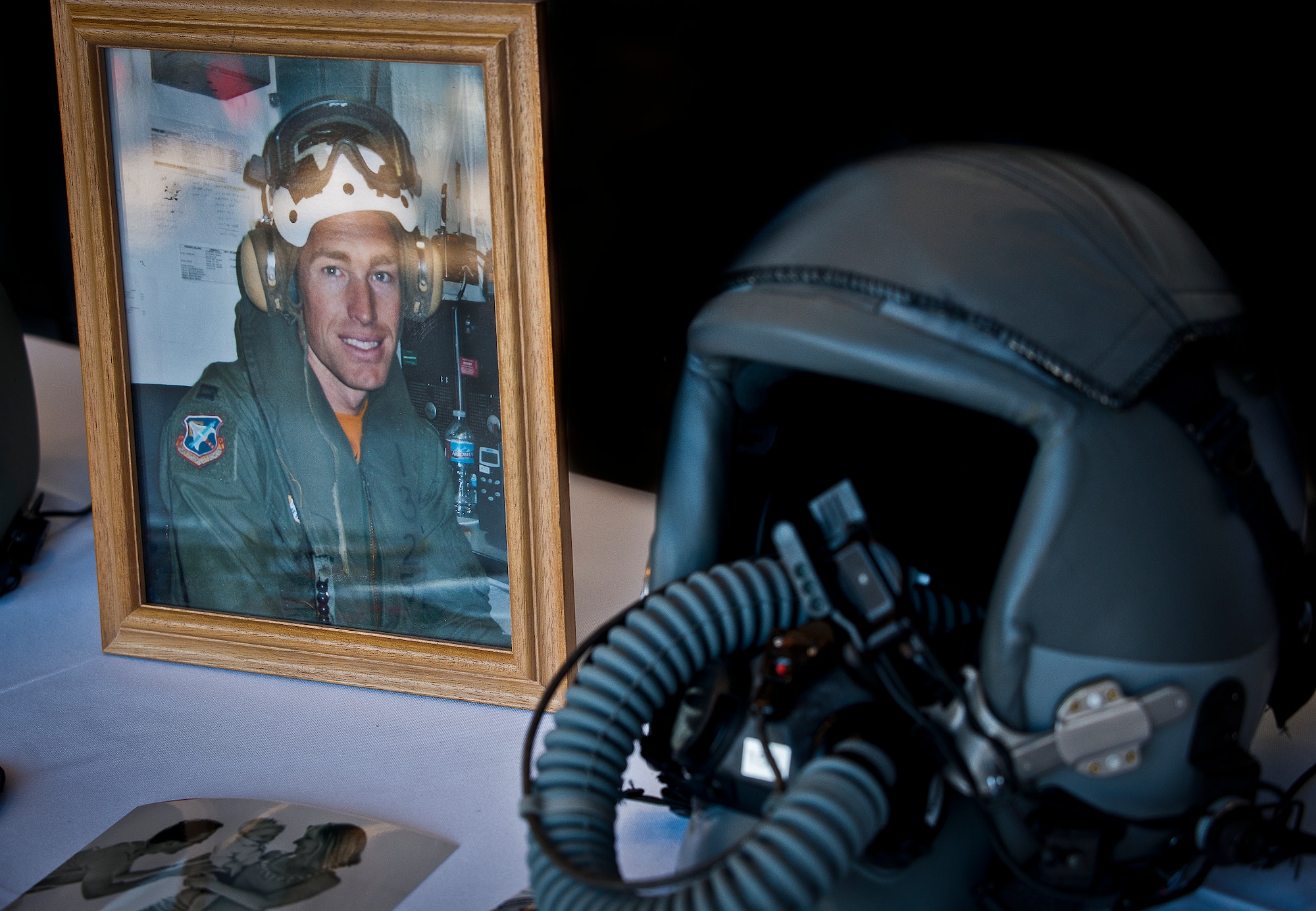 Photos and displays paying tribute to Maj. Garrett Knowlan’s career, family and life were on view at the memorial ceremony held for him, Nov. 5 at Eglin Air Force Base, Fla.  Knowlan died while participating in Air Force Survival, Evasion, Resistance and Escape training at the Naval Air Station in Pensacola.  The memorial service brought family, friends and co-workers together to say their final goodbyes.  (U.S. Air Force photo/Samuel King Jr.)