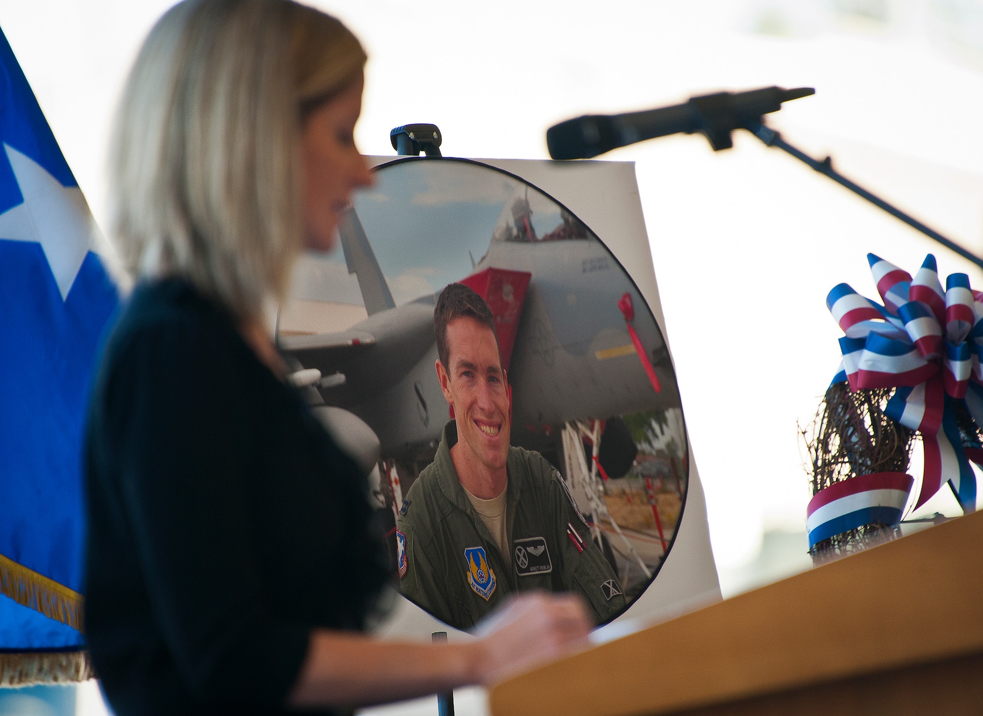 Megan Knowlan speaks to the crowd about her husband, Maj. Garrett Knowlan, the 96th Test Wing executive officer, at a memorial ceremony held for him, Nov. 5 at Eglin Air Force Base, Fla.  Knowlan died while participating in Air Force Survival, Evasion, Resistance and Escape training at the Naval Air Station in Pensacola.  The memorial service brought family, friends and co-workers together to say their final goodbyes.  (U.S. Air Force photo/Samuel King Jr.)