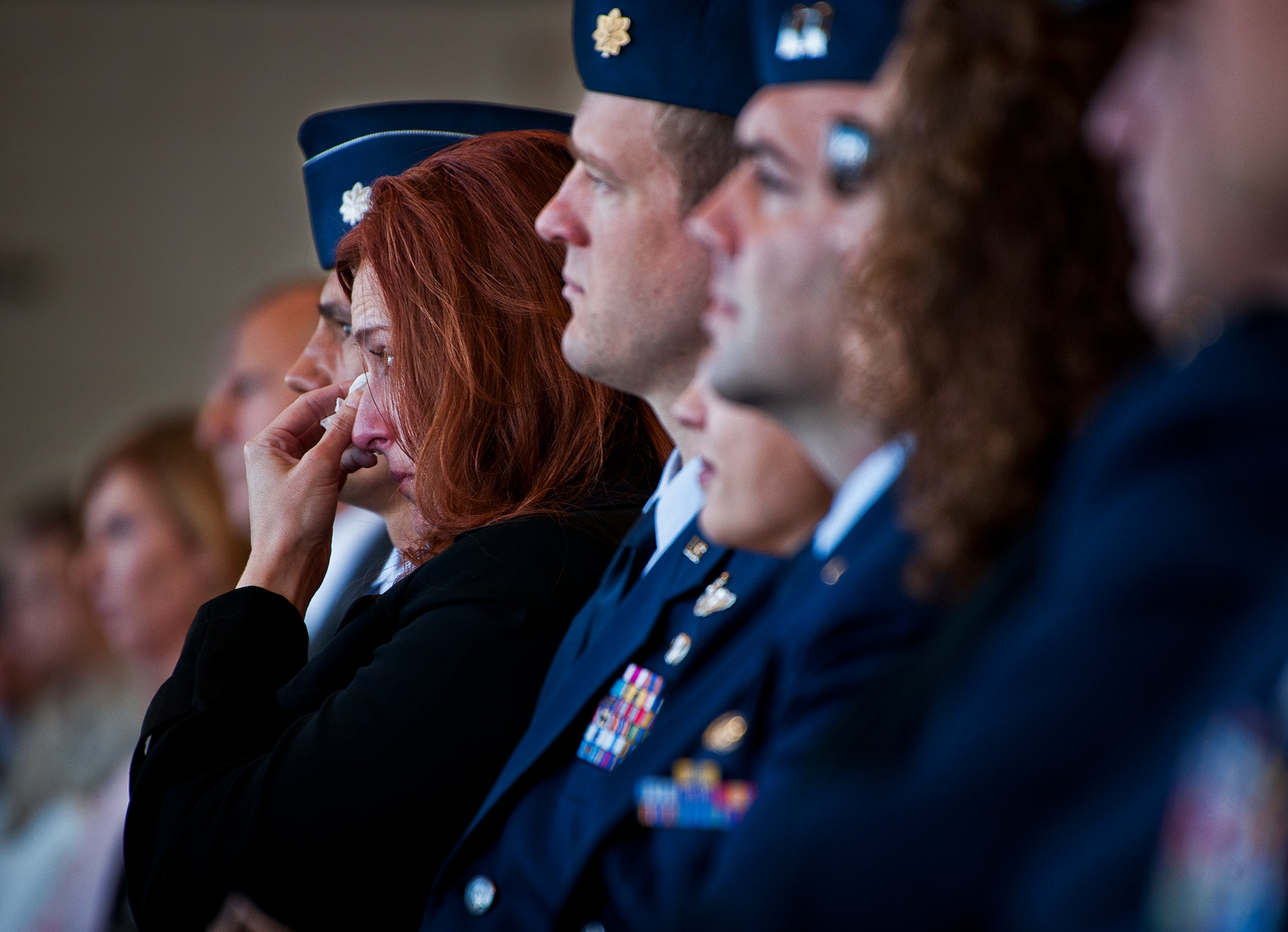 An attendee dabs a tear from her eye during the memorial ceremony for Maj. Garrett Knowlan, the 96th Test Wing executive officer, Nov. 5 at Eglin Air Force Base, Fla.  Knowlan died while participating in Air Force Survival, Evasion, Resistance and Escape training at the Naval Air Station in Pensacola.  The memorial service brought family, friends and co-workers together to say their final goodbyes.  (U.S. Air Force photo/Samuel King Jr.)