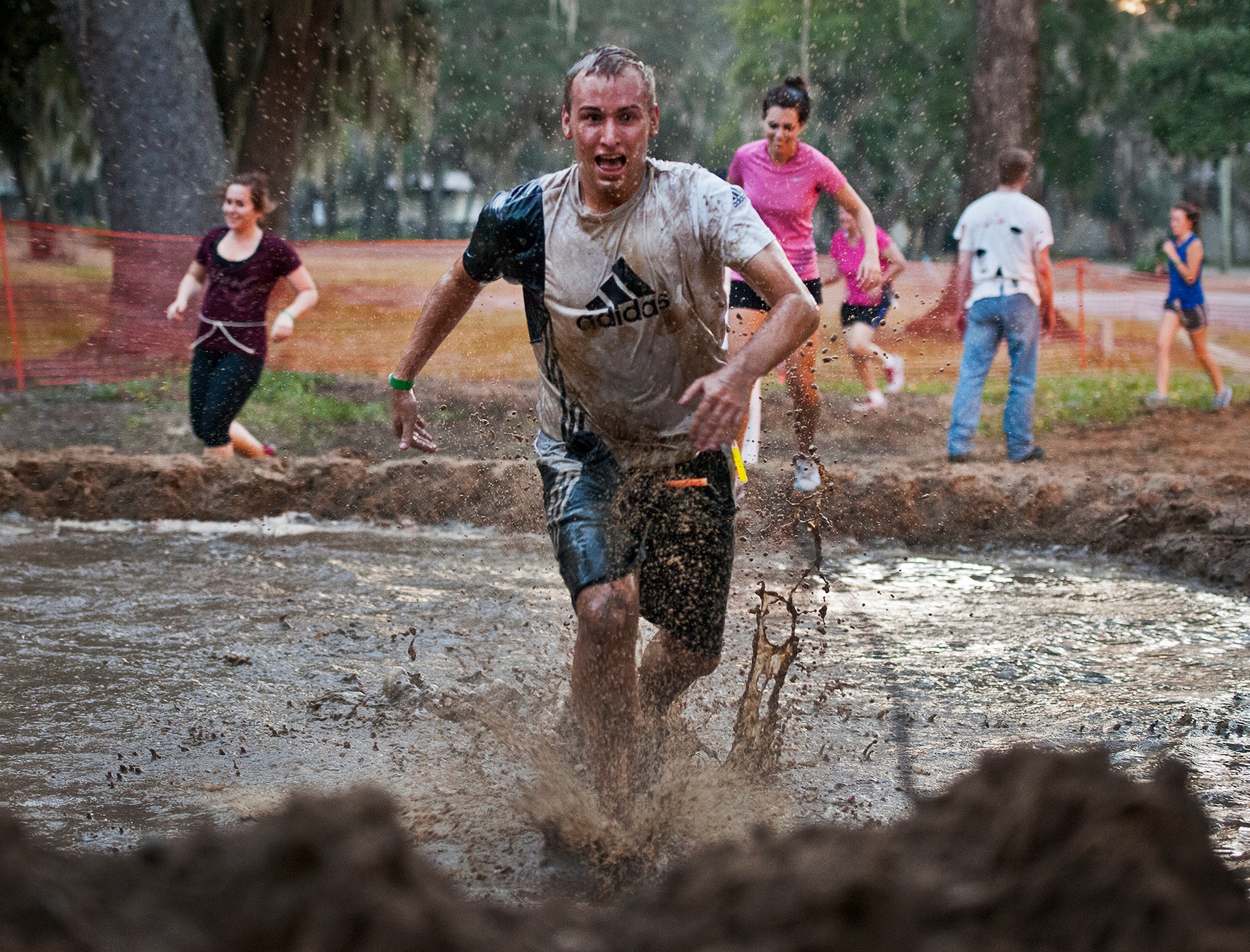 A runner flees for his life through a giant mud pit at the first-ever Zombie Stomp run at Eglin Air Force Base, Fla., Nov. 3.  More than 425 fearless runners braved zombie-infested woods, water and mud hazards and other obstacles over a 4.5 mile course.  (U.S. Air Force photo/Samuel King Jr.)