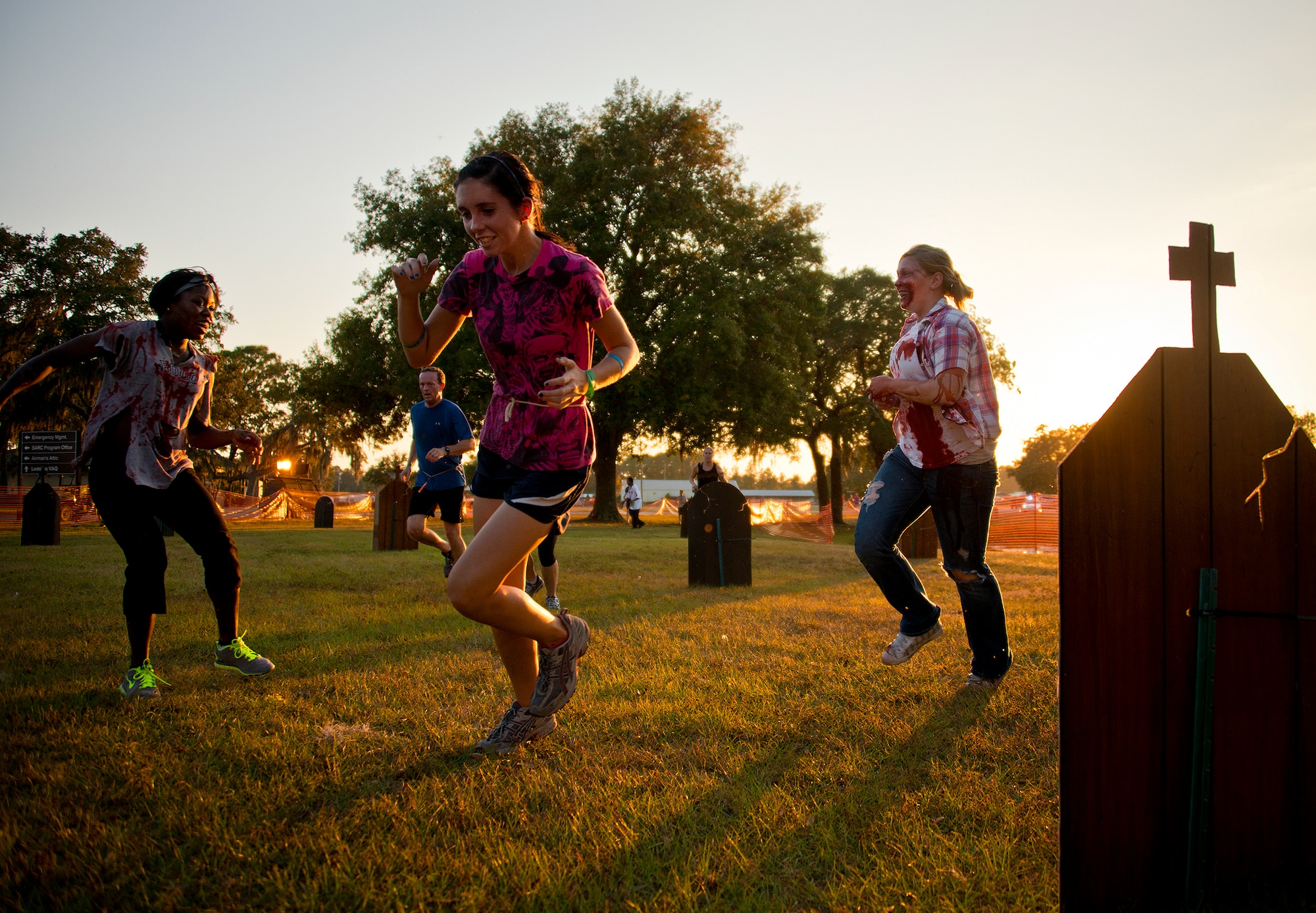 Zombies chase down a runner at the first-ever Zombie Stomp run at Eglin Air Force Base, Fla., Nov. 3.  More than 425 fearless runners braved zombie-infested woods, water and mud hazards and other obstacles over a 4.5 mile course.  (U.S. Air Force photo/Samuel King Jr.)