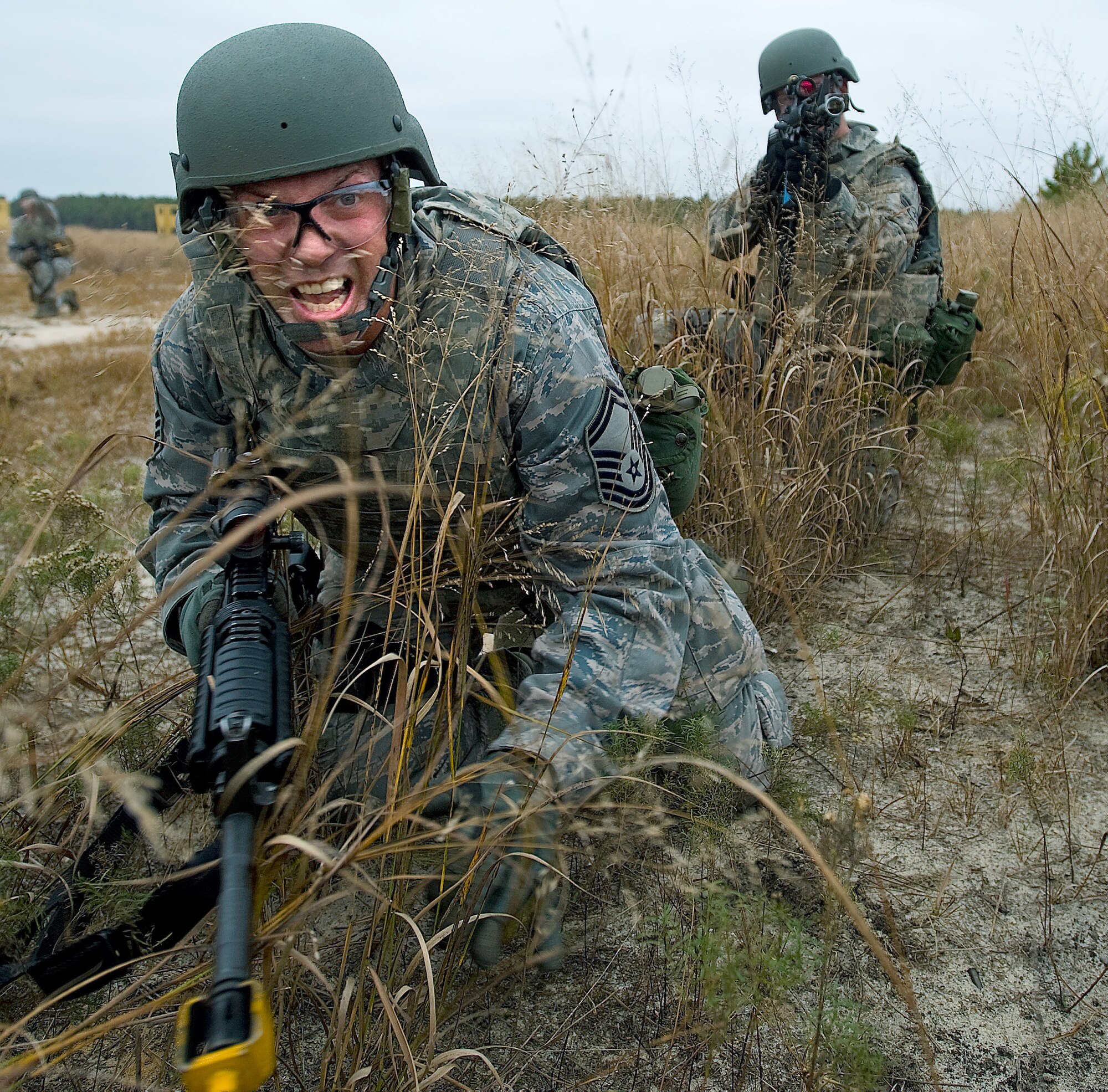 Senior Master Sgt. Daniel Spain, foreground, air freight superintendant with the 436th Aerial Port Squadron, issues a command to Airman 1st Class Jack Sand, background, cargo processing specialist with the 436th Aerial Port Squadron, during the Combat Airman Skills Training field training exercise Oct. 25, 2012, at Joint Base McGuire-Dix-Lakehurst, N.J. Twenty aerial porters from the 436th APS completed CAST in preparation for a deployment. (U.S. Air Force photo by Airman 1st Class Sam Taylor)