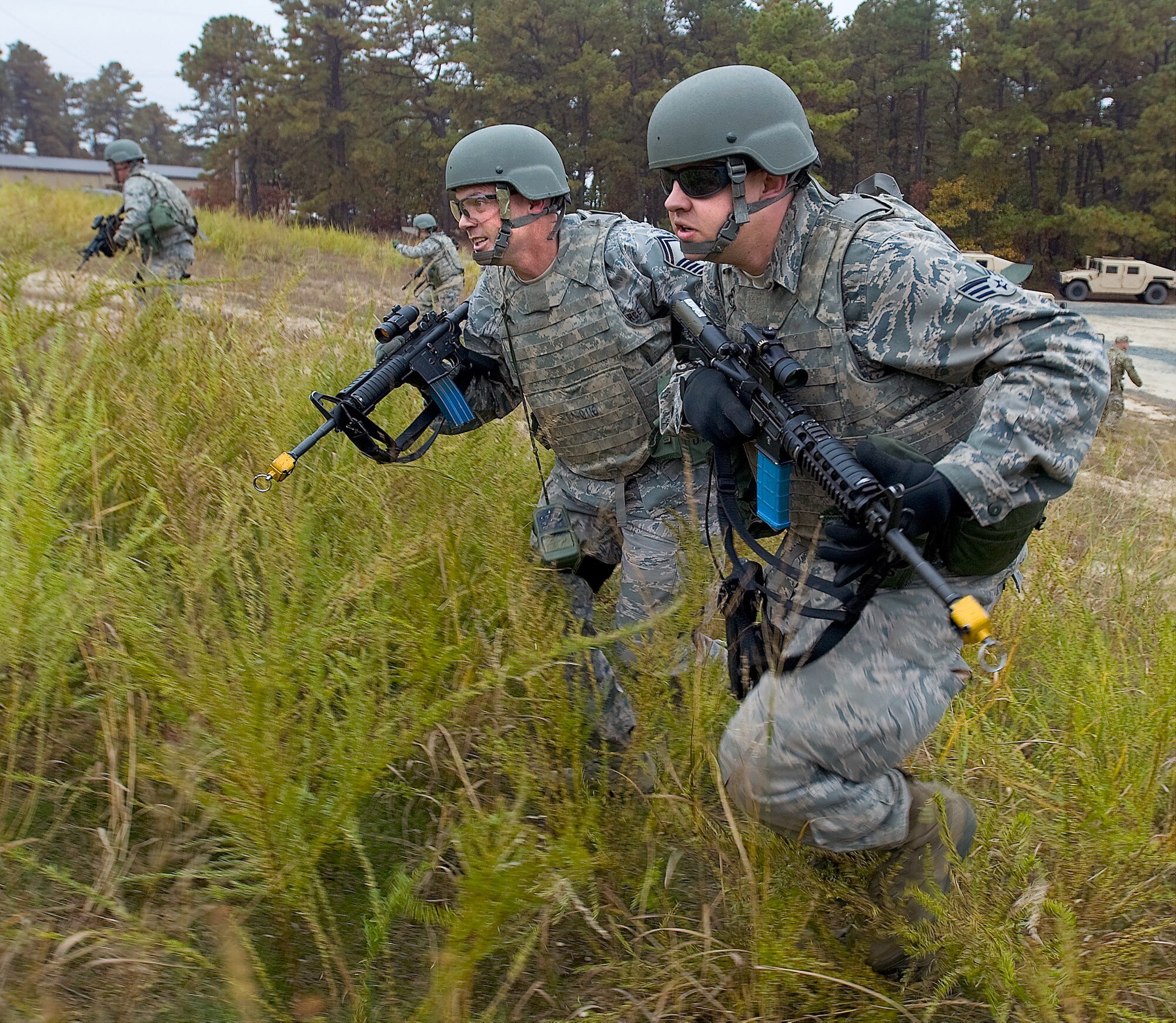 Senior Master Sgt. Daniel Spain, left, air freight superintendant with the 436th Aerial Port Squadron, and Senior Airman Jonathon Martin, cargo processing specialist with the 436th Aerial Port Squadron, charge up a hill during the Combat Airman Skills Training field training exercise Oct. 25, 2012, at Joint Base McGuire-Dix-Lakehurst, N.J. The FTX tested the skills Airmen learned during the 10-day CAST course. (U.S. Air Force photo by Airman 1st Class Sam Taylor)  