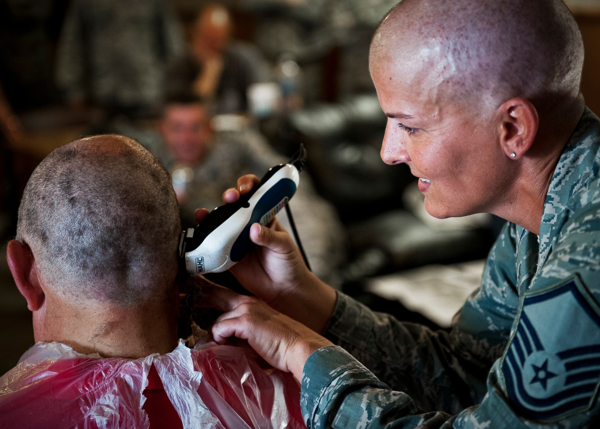 Master Sgt. Catherine Holland, of the 96th Fuels Management Flight, completes another shave during a Combined Federal Campaign fundraising event Nov. 2 at Eglin Air Force Base, Fla.  The event was in support of Holland, who had a double mastectomy in August and is currently undergoing chemotherapy treatment.  The fundraiser to see who would get their head shaved by Holland raised $722 dollars for the Susan G. Komen Foundation.  (U.S. Air Force photo/Samuel King Jr.)