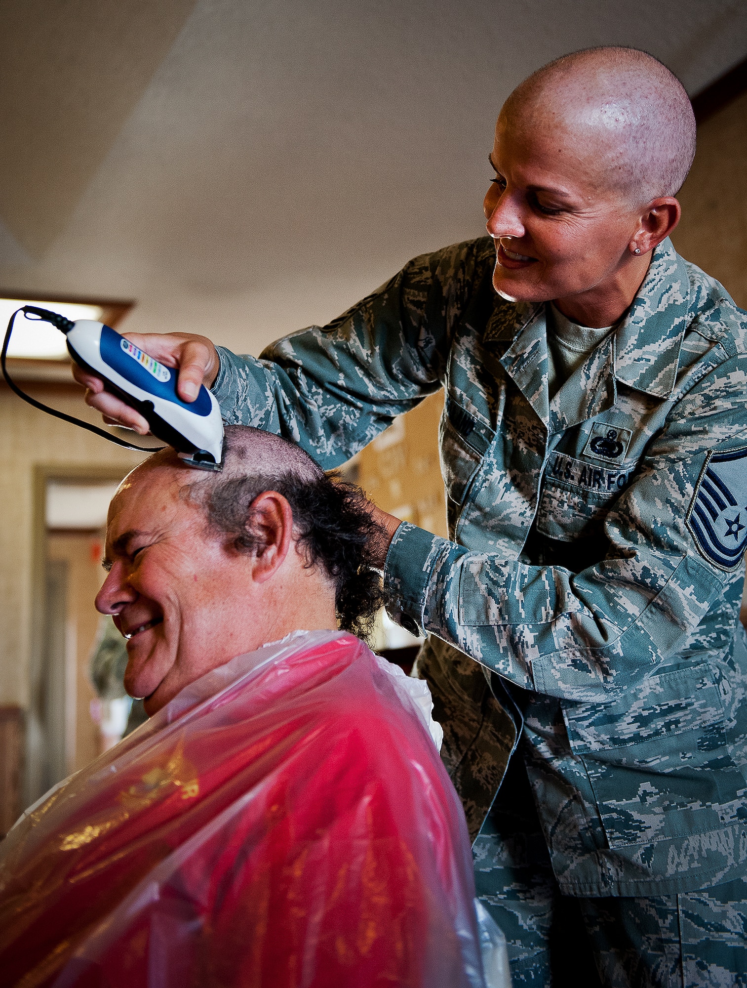 Joseph Proctor, of the 96th Logistics Readiness Squadron, reacts to having his head shaved by Master Sgt. Catherine Holland, of the 96th Fuels Management Flight, during a Combined Federal Campaign fundraising event Nov. 2 at Eglin Air Force Base, Fla.  The event was in support of Holland, who had a double mastectomy in August and is currently undergoing chemotherapy treatment.  The fundraiser to see who would get their head shaved by Holland raised $722 dollars for the Susan G. Komen Foundation.  Proctor and three others received the most donations/votes to see them get their head shaved.  (U.S. Air Force photo/Samuel King Jr.)