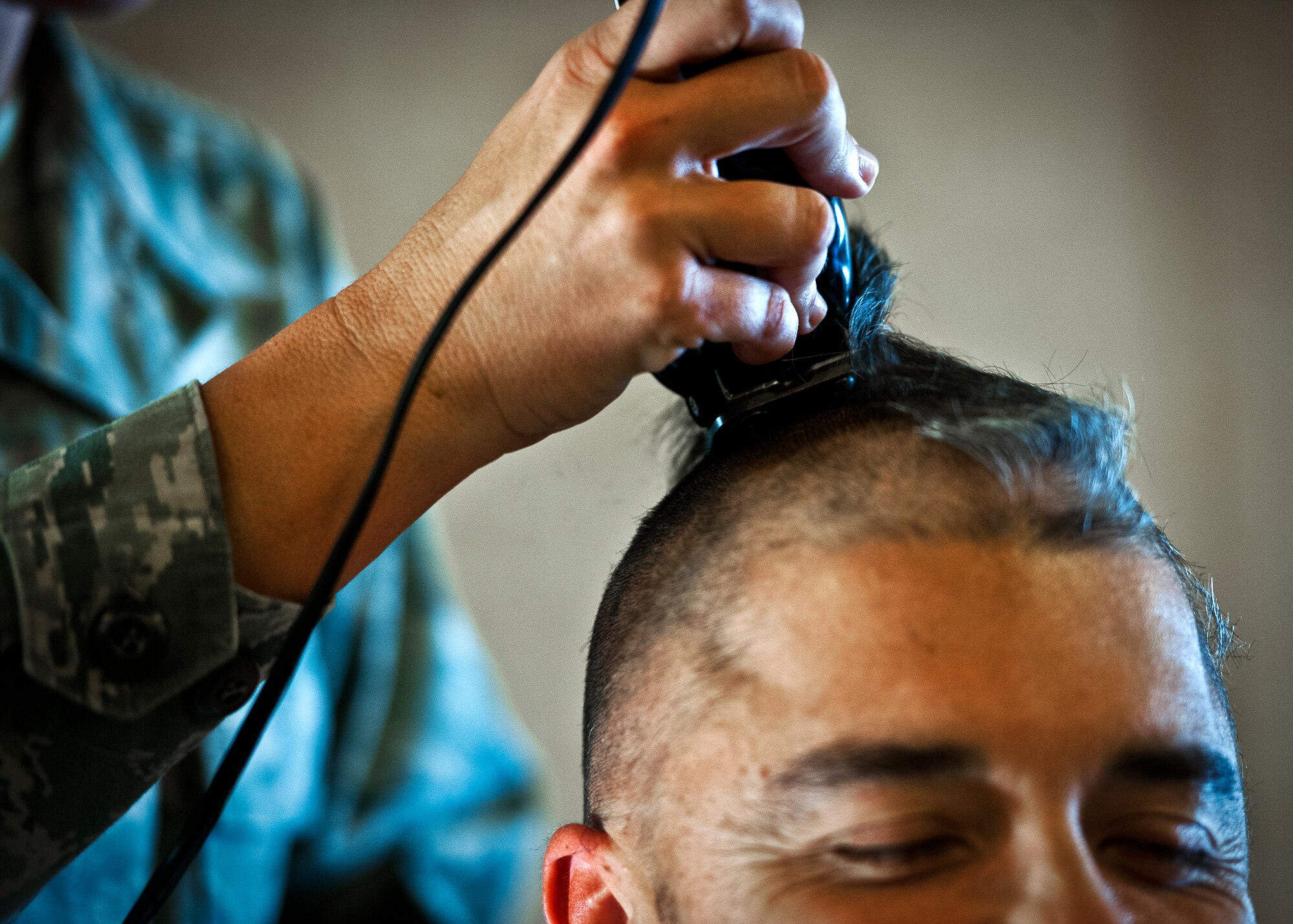 Master Sgt. William Murphy, of the 96th Fuels Management Flight, has another chunk of hair removed during a Combined Federal Campaign fundraising event Nov. 2 at Eglin Air Force Base, Fla.  The event was in support of the barber, Master Sgt. Catherine Holland, also of the fuels flight, who had a double mastectomy in August and is currently undergoing treatment for breast cancer.  The fundraiser to see who would get their head shaved raised $722 dollars for the Susan G. Komen Foundation.  Murphy and three others received the most donations/votes to see them get their head shaved.  (U.S. Air Force photo/Samuel King Jr.)
