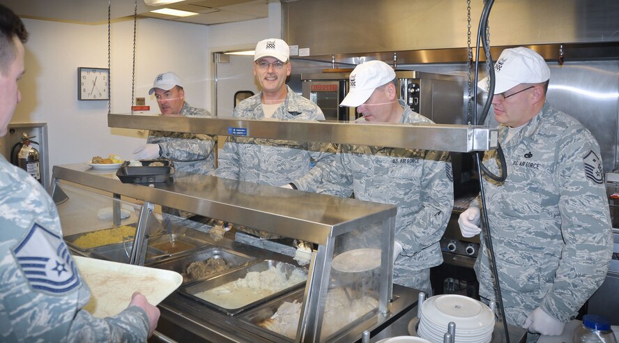 Master Sgt. David Labeause, Chief Master Sgt. Mark Koenig, Master Sgt. Thomas Schulte and Master Sgt. Brenton Black serve an early Thanksgiving dinner at the Minneapolis-St. Paul Air Reserve Station's Services Club during the Unit Training Assembly, Nov. 3.  (U.S. Air Force photo/Staff Sgt. Kimberly Hickey)