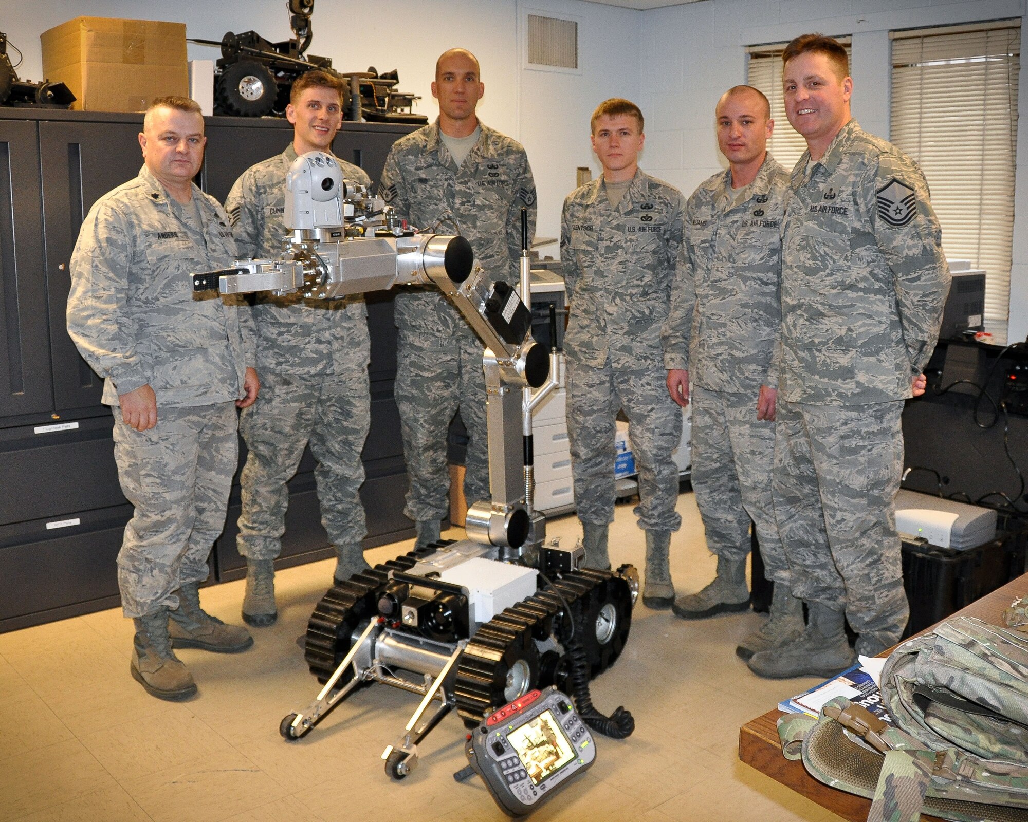 Lt. Col. Bryan G. Anders, Staff Sgt. Robin Cunningham, Staff Sgt. David Rud, Tech. Sgt. Nathan Lentsch, Tech. Sgt. William Williams and Master Sgt. Scott Castleman of the 934th Civil Engineer Squadron Explosive Ordnance Disposal Flight pose with their medium sized robot Nov. 3.  The Air Force Reserve Command's award recognizes the Flight as the year's top perfomer.  (U.S. Air Force photo/Staff Sgt. Kimberly Hickey) 