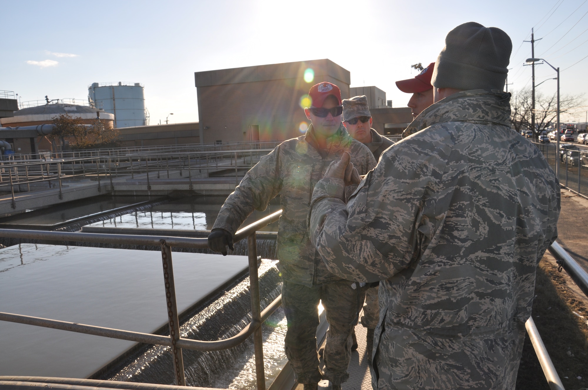 Members of the 331st Air Expeditionary Group discuss plans for assisting the Rockaway wastewater treatment facility in clearing the 500,000 gallon water tanks affected by Hurricane Sandy, Nov. 5, 2012. The 331st AEG is a unit comprised of Air Force civil engineers from 5 different duty locations across the country, whose mission is to support the joint service mission to pump flood waters in critical areas along the New York coastline. (U.S. Air Force photo by Capt. Sybil Taunton/Released)