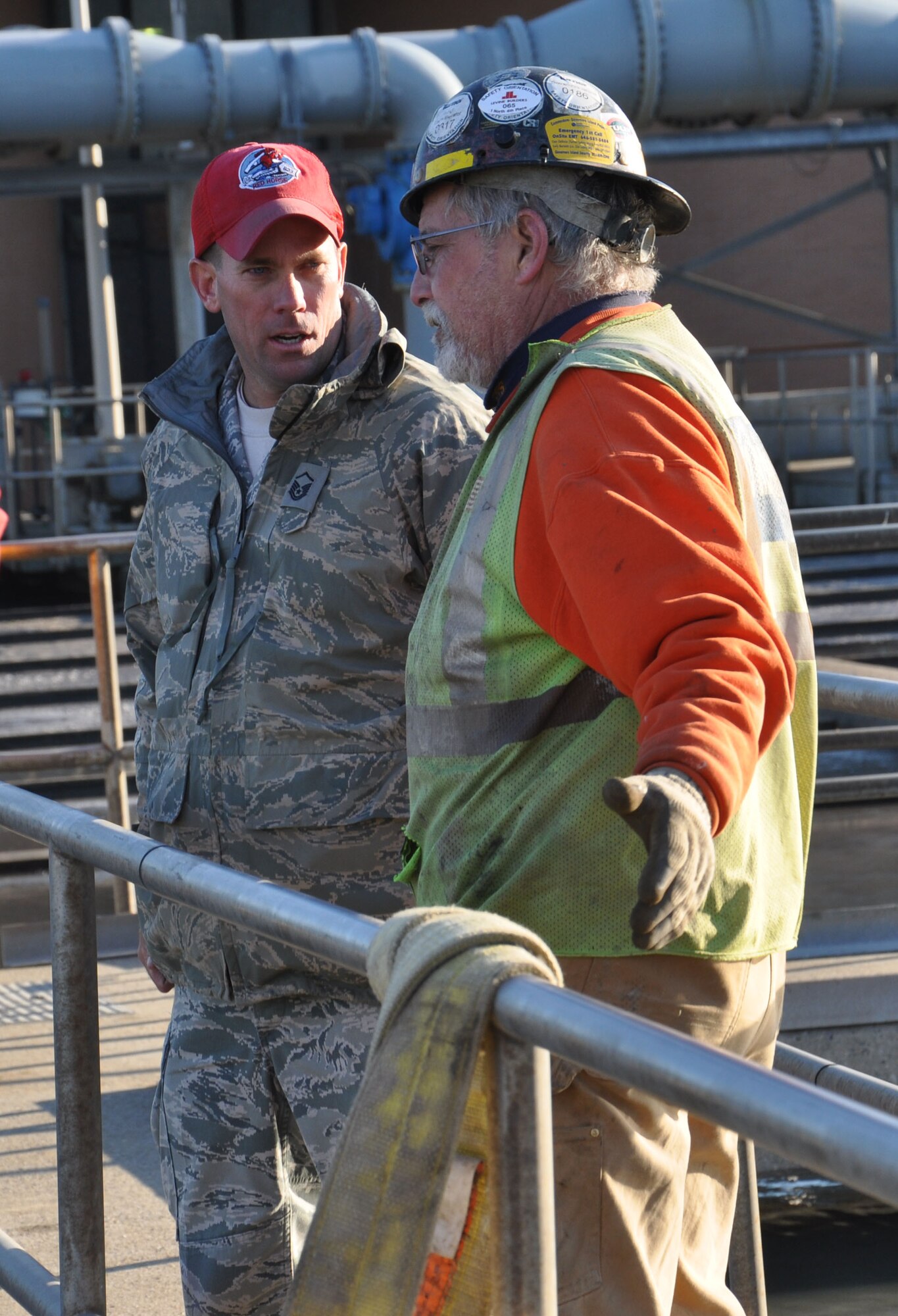 Master Sgt. Joseph Ferris, of the 823rd Red Horse Squadron, from Hurlburt Field, Fla., discusses a plan with a representative of the Rockaway wastewater treatment facility to clear sewage and debris blocking the tanks from properly processing water, Nov. 5, 2012. Approximately 50 Air Force civil engineers and 12 industrial pumps were sent from different locations around the country to form the 331st Air Expeditionary Group, whose mission to help pump flood water from critical areas damaged by Hurricane Sandy. The 331st AEG are utilizing Joint Base McGuire-Dix-Lakehurst, N.J., facilities and equipment to assist their support operations.  (U.S. Air Force photo by Capt. Sybil Taunton/Released)