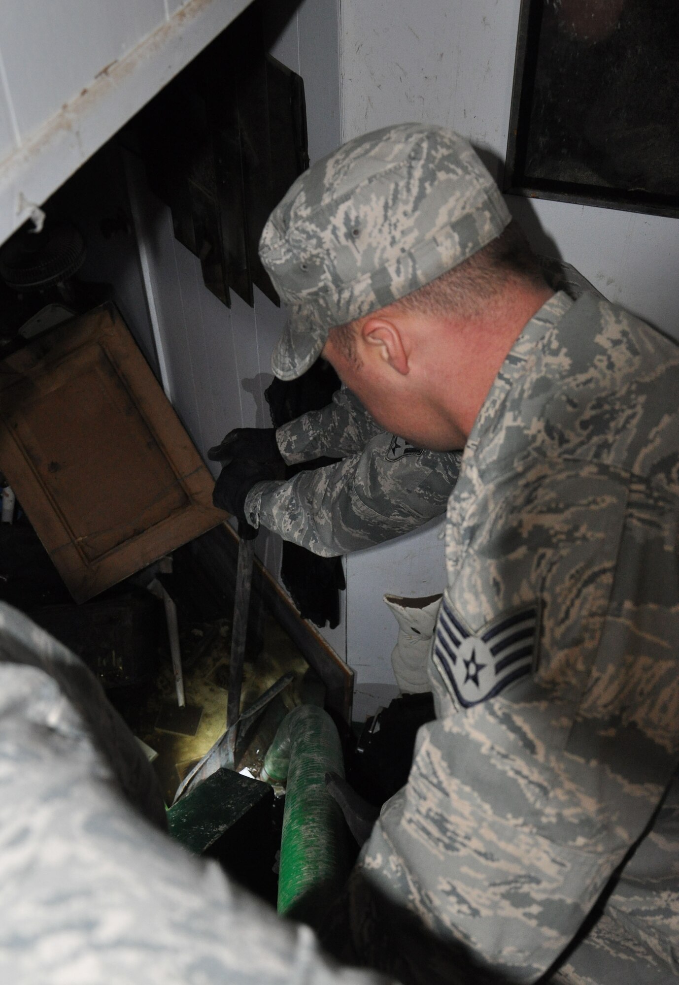Members of the 331st Air Expeditionary Group work to clear debris and flood water from the basement of a Coney Island residence, Nov. 5, 2012. Approximately 50 Air Force civil engineers and 12 industrial pumps were sent from different locations around the country to form the 331st AEG, who utilized Joint Base McGuire-Dix-Lakehurst, N.J., equipment and facilities to assist in their support efforts following the Hurricane Sandy.  (U.S. Air Force photo by Capt. Sybil Taunton/Released)