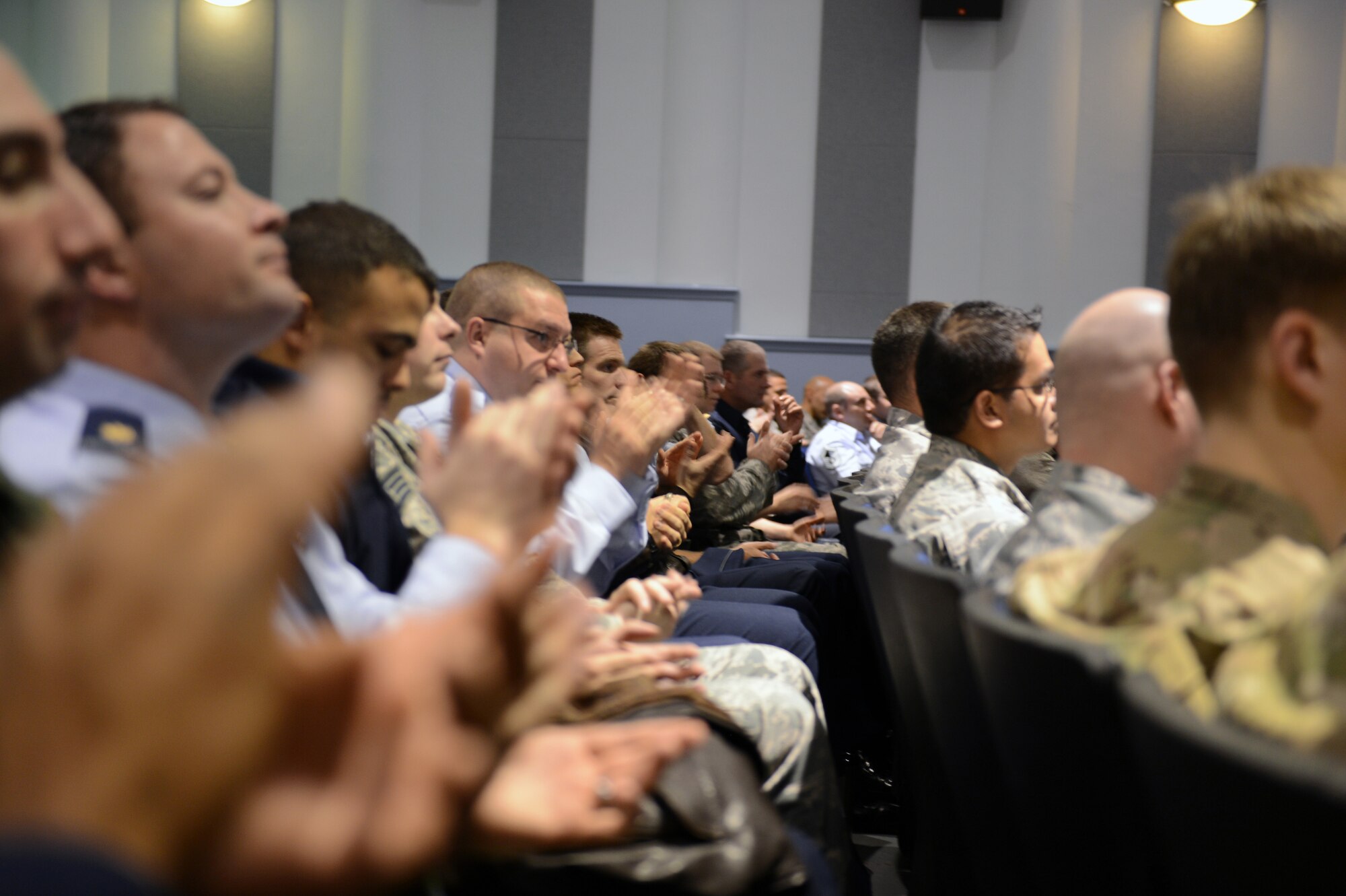 Airmen from the 62nd Airlift Wing and 627th Air Base Group applaud as they were deemed "mission ready" during an Operational Readiness Inspection outbrief Nov. 5, 2012 at Joint Base Lewis-McChord, Wash. The ORI, which took place Oct. 13 to 20 at the Volk Field Combat Readiness Training Center, Wis., tested the units’ ability to conduct its wartime mission. (U.S. Air Force photo/Master Sgt. Todd Wivell)