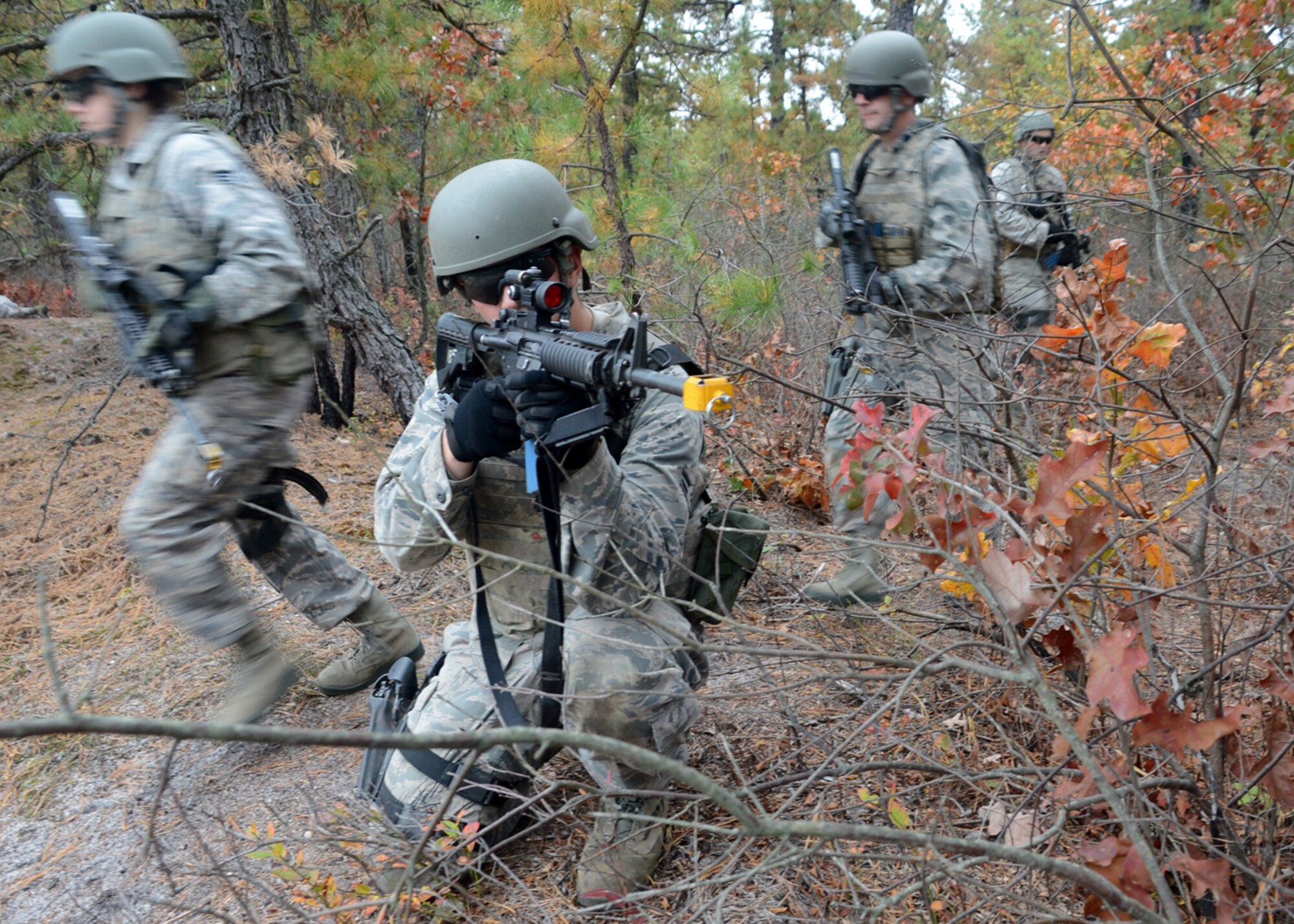 Airman 1st Class Kenneth Taylor, of the 436th Aerial Port Squadron, provides cover while other members of his team cross a road during a Field Training Exercise Oct. 25, 2012, at Joint Base McGuire-Dix-Lakehurst, NJ. The FTX was part of the Combat Airman Skills Training course in which 20 Team Dover Airmen participated in for preparation for an upcoming deployment. (U.S. Air Force photo by Tech. Sgt. Chuck Walker)