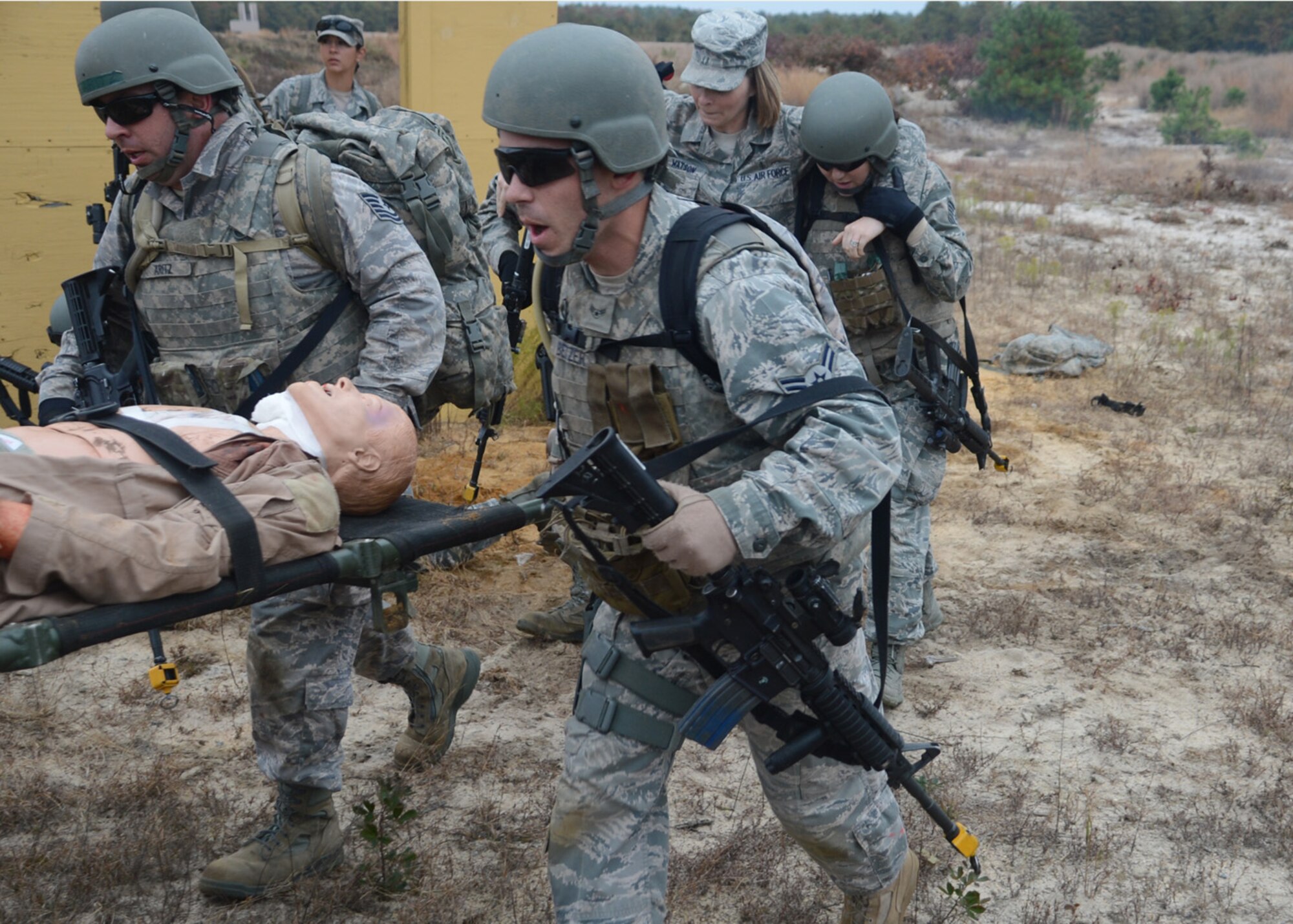 Participants in a Field Training Exercise extricate injured personnel to the helicopter pick up point Oct. 25, 2012, at Joint Base McGuire-Dix-Lakehurst, NJ. The personnel participated in the Combat Airman Skills Training course which prepares Airmen for deployment. (U.S. Air Force photo by Tech. Sgt. Chuck Walker)