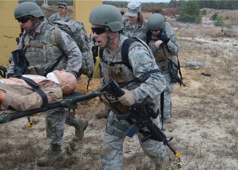 Participants in a Field Training Exercise extricate injured personnel to the helicopter pick up point Oct. 25, 2012, at Joint Base McGuire-Dix-Lakehurst, NJ. The personnel participated in the Combat Airman Skills Training course which prepares Airmen for deployment. (U.S. Air Force photo by Tech. Sgt. Chuck Walker)
