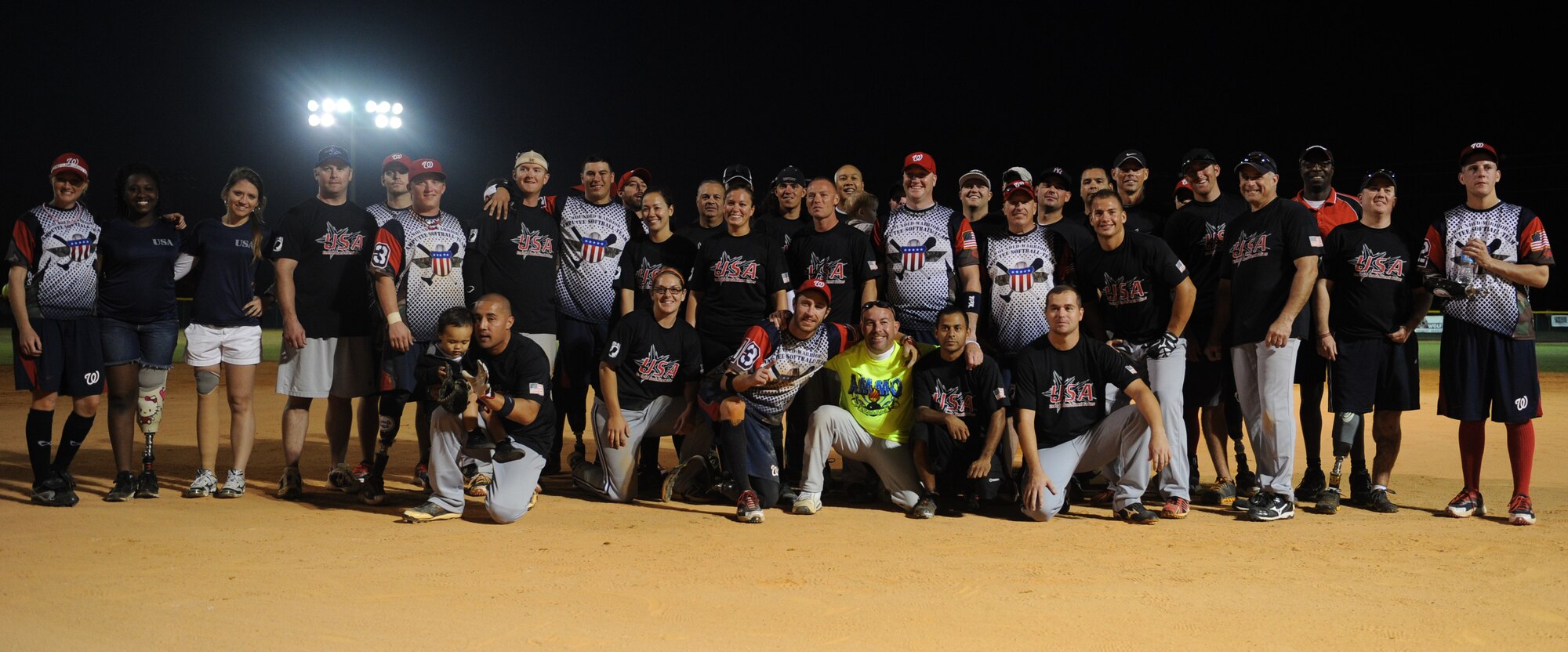 Team members from both the Wounded Warrior Amputee and the Northwest Florida Armed Services softball teams pose for a group photo at the Morgan Sports Complex in Destin, Fla., Nov. 3, 2012. The game is one stop out of a 40 city tour for the Wounded Warriors.(U.S. Air Force photo/Senior Airman Eboni Reams)
