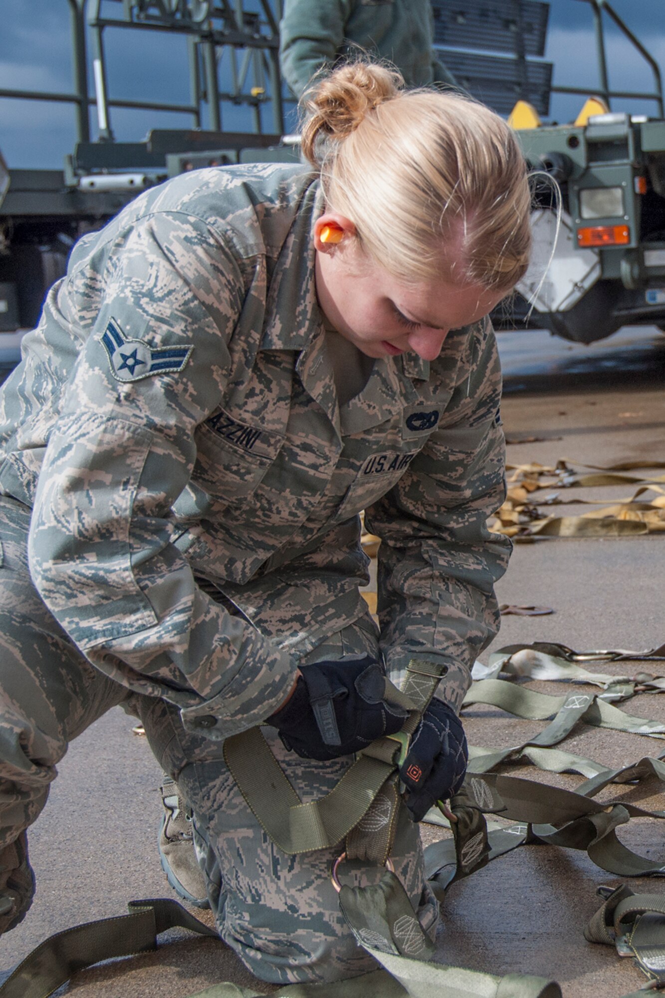 YOUNGSTOWN AIR RESERVE STATION, Ohio – U.S. Air Force Reserve Airman 1st Class Brittny Frazzini, cargo specialist assigned to the 76th Aerial Port Squadron, loosens cargo nets to secure pallets to be put on a C-5 for the Mission of Love to Guatemala Nov. 3, 2012. YARS partners with Mission of Love each year to provide donated items to Guatemalans in need. (U.S. Air Force photo/Staff Sgt. Megan Tomkins).