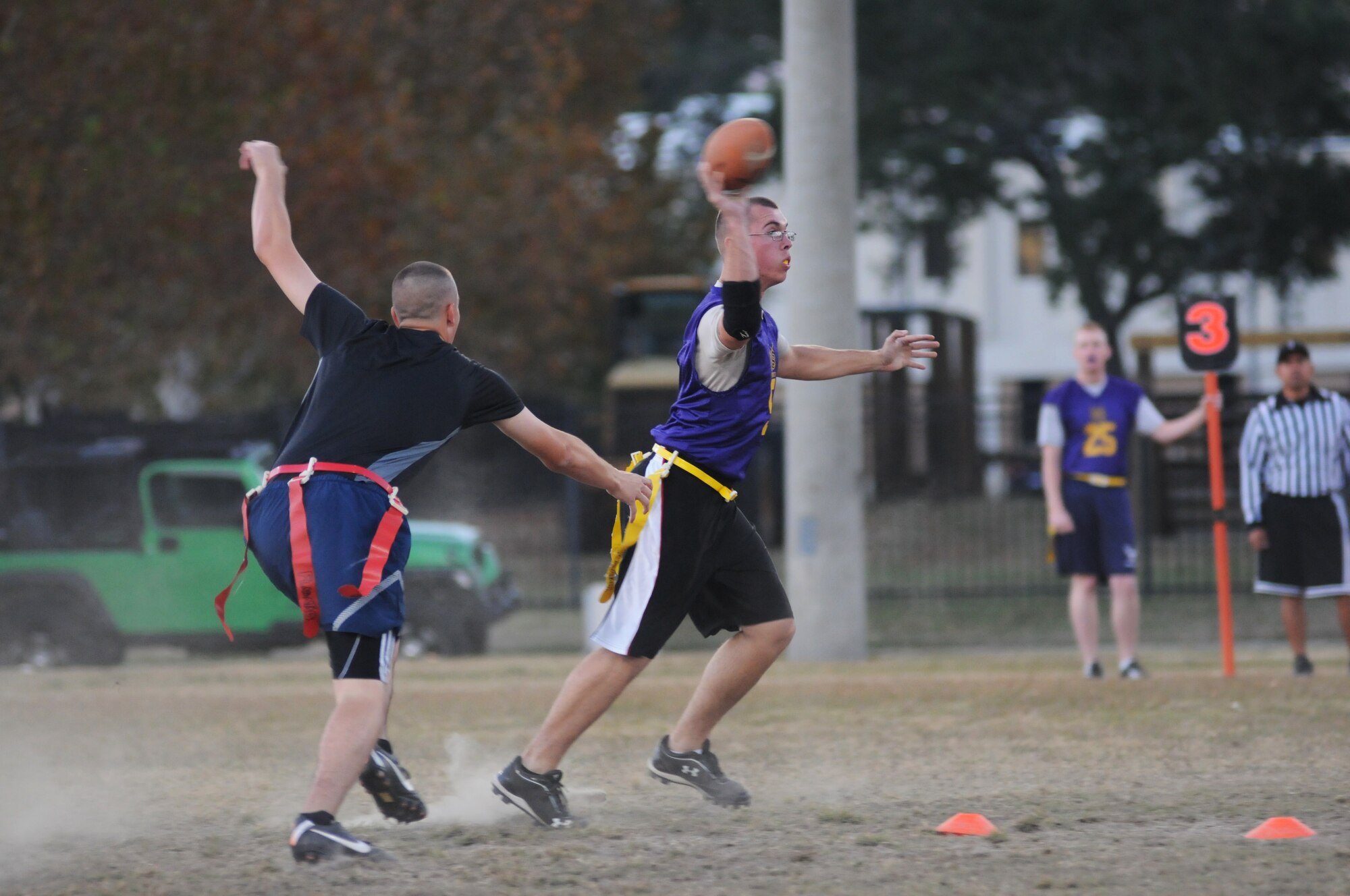 Matt Fisher, 335th Training Squadron, reaches for the flag of Collin Benton, 338th Training Squadron quarterback, as he looks for a team-mate to make a pass to during an intramural flag football game against the 335th Training Squadron Nov. 1, 2012, at Keesler Air Force Base, Miss.  The Bulls defeated the Dark Knights, 26-20. (U.S. Air Force photo by Kemberly Groue)