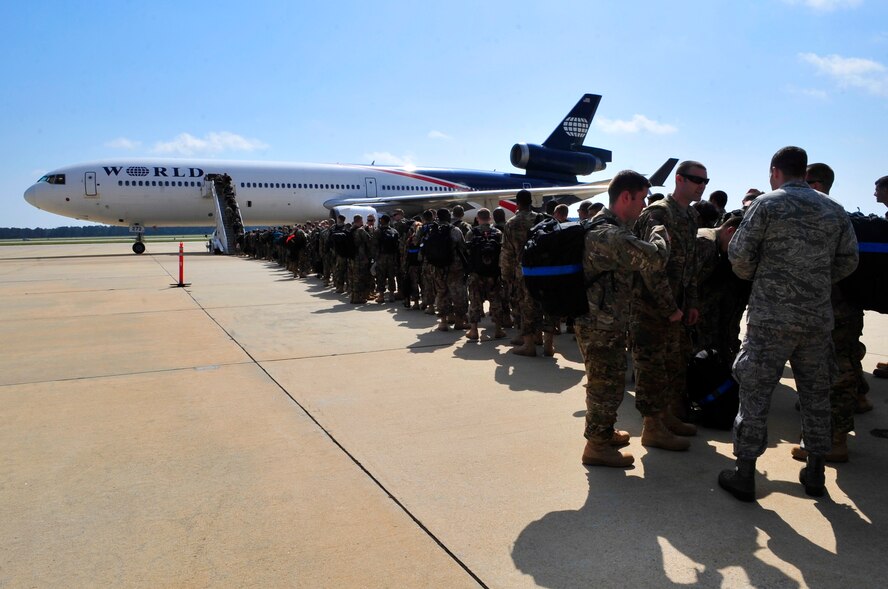 Team Shaw members from the 77th Fighter Squadron board an aircraft for a deployment to an undisclosed location in Southwest Asia from Shaw Air Force Base, Oct. 5, 2012. (U.S. Air Force photo by Airman Nicole Sikorski/Released)