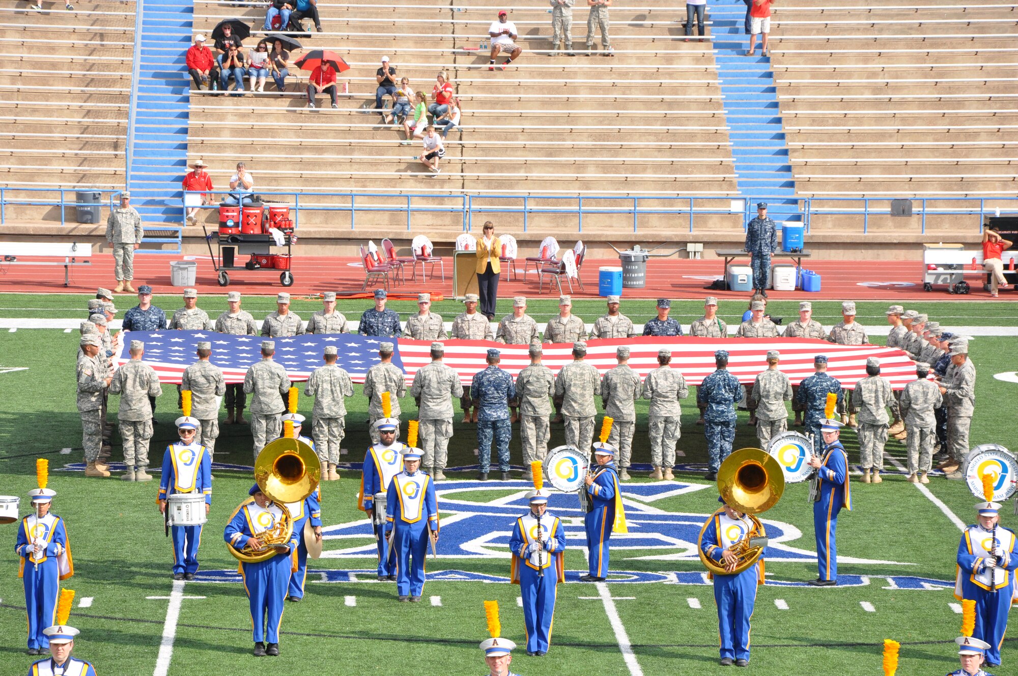 SAN ANGELO, Texas-  Volunteers from Goodfellow Air Force Base unfurl the American flag during halftime at the Angelo State University Military Appreciation Day football game Nov. 3 in San Angelo.  All military personnel and family were invited by ASU to attend, the Military Appreciation Day on ASU campus and at the football stadium. (U.S. Air Force photo/ Airman 1st Class Erica Rodriguez)