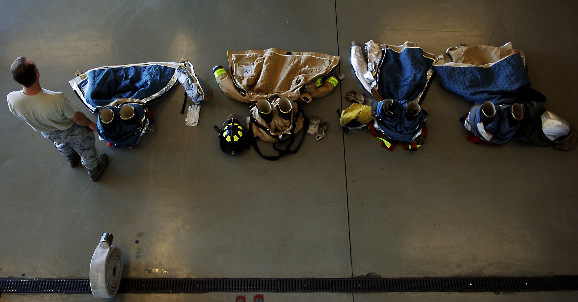 Chaplain Capt. David Barns, 633rd Air Base Wing chaplain, waits for the rest of his team during Chaplain’s Challenge with the Langley Air Force Base, Va., fire department, Nov. 1, 2012.  Events in the challenge included donning protective gear, throwing and rerolling a fire house, and ladder placement. (U.S. Air Force photo by Staff Sgt. Katie G. Ward / Released)