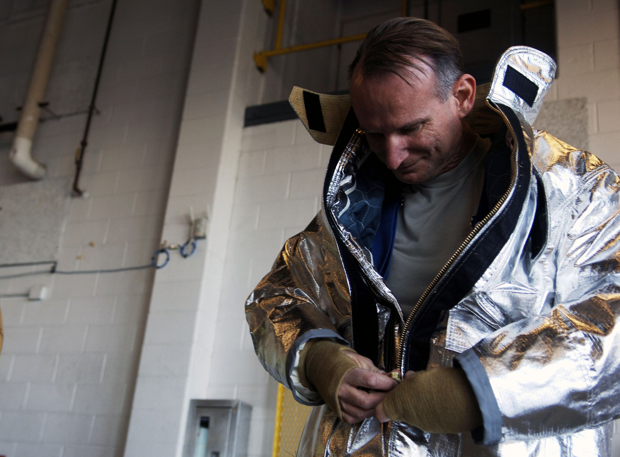 Chaplain Capt. David Barns, 633rd Air Base Wing chaplain, dons protective gear in during the first event of the Chaplain’s Challenge with the Langley Air Force Base, Va., fire department, Nov. 1, 2012.  The objective of the Chaplain’s Challenge is to boost morale, test job knowledge, and build relationships with squadron members. (U.S. Air Force photo by Staff Sgt. Katie G. Ward / Released)