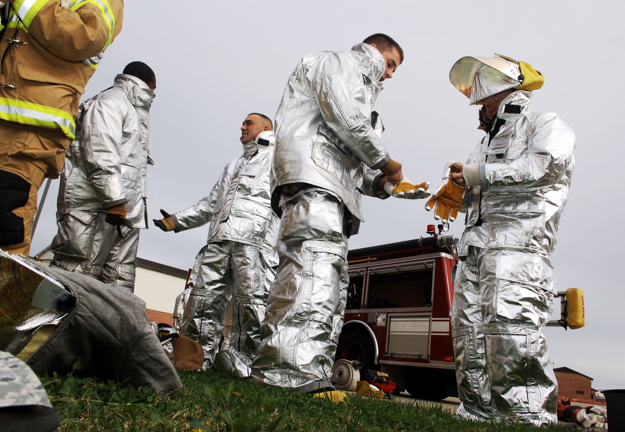 Chaplain Capt. Michael McDonald (right), 633rd Air Base Wing chaplain, is fitted for protective gear in preparation for the Chaplain’s Challenge with the Langley Air Force Base, Va., fire department, Nov. 1, 2012.  This is the first time they have brought the challenge to the fire department. (U.S. Air Force photo by Staff Sgt. Katie G. Ward / Released)