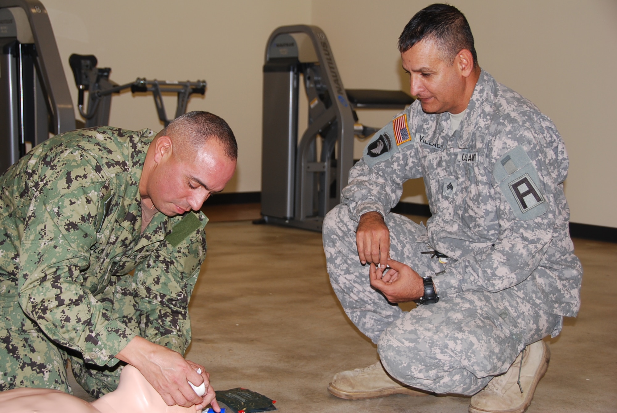 JOINT BASE MCGUIRE-DIX-LAKEHURST, N.J. -- Coast Guard Petty Officer 1st Class Rodney Colon practices inserting an NPA (Nasopharyngeal Airway) in a manikin during Combat Lifesaver training instructed by Army Sgt. Juan Villacis, 174th Infantry Brigade CLS Trainer/Mentor, Nov. 1. The training was moved to the brigade headquarters gym due to the power outage at the CLS building from Hurricane Sandy. (U.S. Army photo by  Capt. Antonia T. Greene-Edwards/Released)
