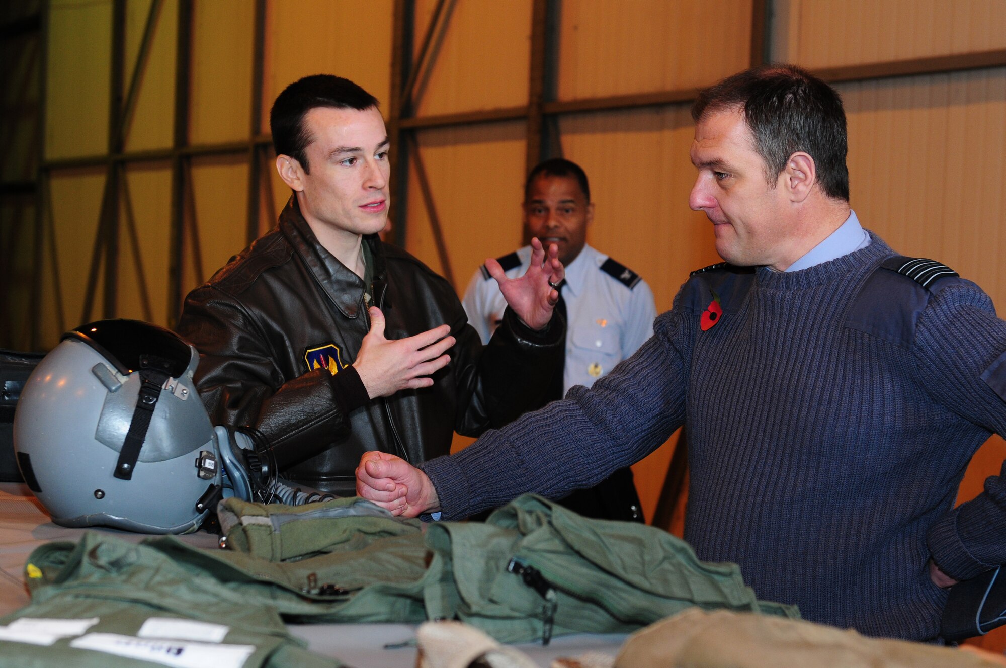 ROYAL AIR FORCE LAKENHEATH, England – U.S. Air Force Capt. Bryant Roberts, 492nd Fighter Squadron weapon systems officer, speaks with Royal Air Force Group Capt. Mike Foster, Legal Advisory Air Command, about aircrew flight equipment during an F-15 capabilities tour Oct. 30, 2012. Members of the RAF Legal Services visited RAFs Mildenhall and Lakenheath to view the U.S. Air Forces in Europe Judge Advocate’s mission and to attend a host nation legal conference.  (U.S. Air Force photo by Airman 1st Class Cory D. Payne)