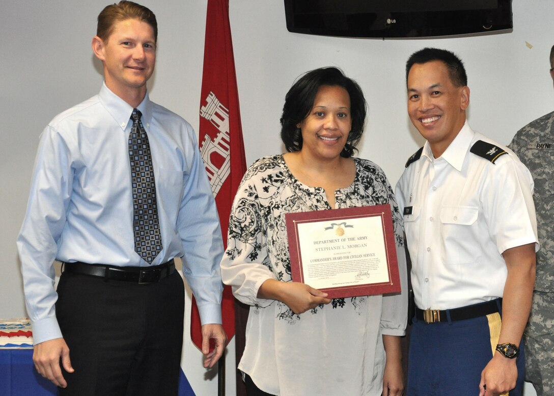 PHOENIX - Stephanie Morgan, a project engineer for the U.S. Army Corps of Engineers Los Angeles District Arizona-Nevada Area Office's Roadrunner Resident Office, receives a Commander's Award for Civilian Service from Col. Mark Toy, the LA District's commander, and David Van Dorpe, the LA District's Deputy District Engineer for Programs and Project Management during a Nov. 1 awards ceremony. Toy and Van Dorpe presented awards and welcomed back team members who had recently returned from deployments overseas.