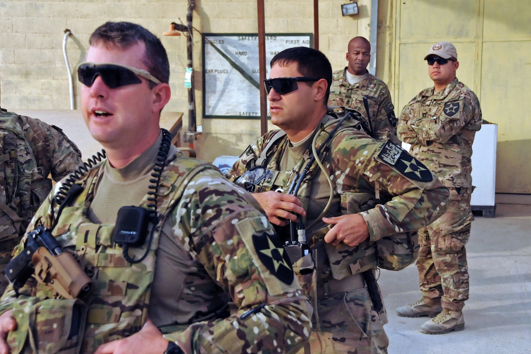 U.S. Army 1st Lt. Ryan Schulte, front, and Sgt. 1st Class Sal Somoza ...