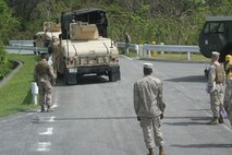 Marines guide vehicles during licensed vehicle driving training at the Central Training Area at Camp Hansen Oct. 22. The unit conducted the training to give Marines the opportunity to adapt to convoy movements in Okinawa. The Marines are with Combat Logistics Battalion 4, Combat Logistics Regiment 3, 3rd Marine Logistics Group, III Marine Expeditionary Force. 