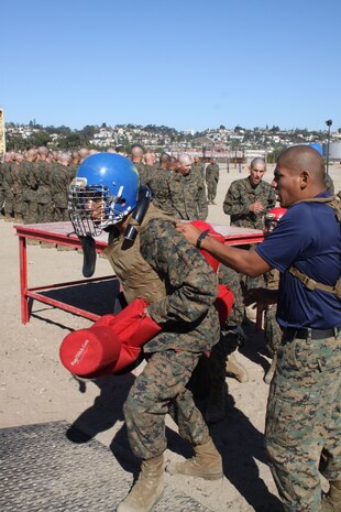 A recruit of Company I, 3rd Recruit Training Battalion, is prepared by his drill instructor for a pugil stick fight aboard Marine Corps Recruit Depot San Diego, Oct. 25. A strike to the head or a recruit falling off the stage signified the end of a bout. Each pugil stick bout lasted approximately 15 seconds.