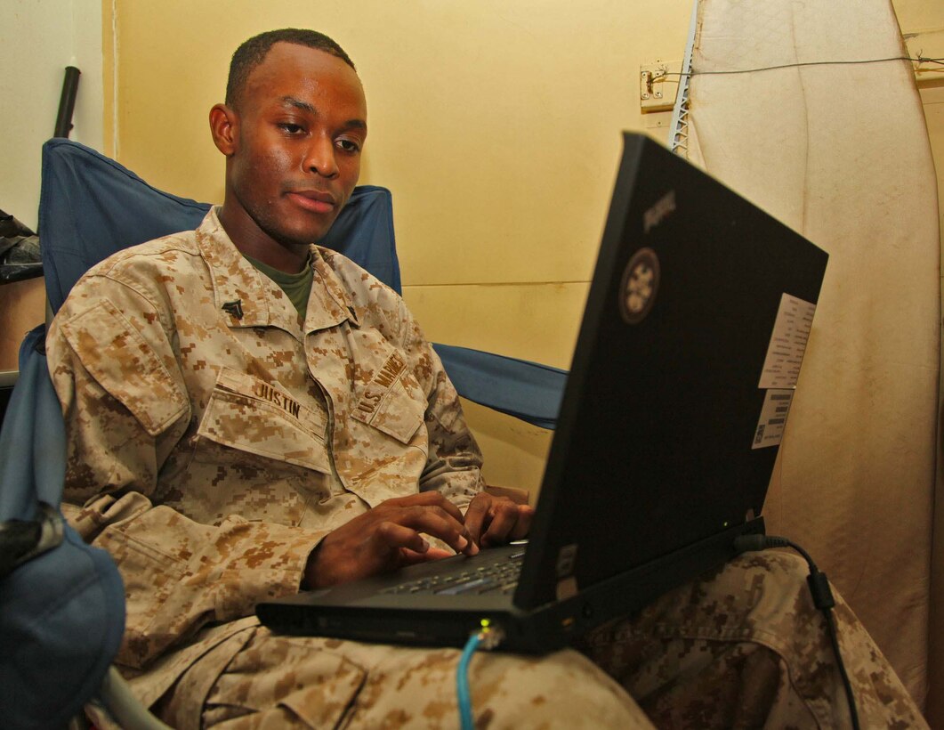 Corporal Pierre K. Justin, administration clerk, Command Element, 15th Marine Expeditionary Unit, works aboard the USS Rushmore, Nov. 5. Justin was born in Port-au-Prince, Haiti, in 1990. At the age of 15, he left the Caribbean and moved to his father's house in New York City. He later joined the Marine Corps and earned his U.S. citizenship. The 15th MEU is deployed as part of the Peleliu Amphibious Ready Group as a theater reserve and crisis response force throughout U.S. Central Command and the U.S. 5th Fleet area of responsibility.