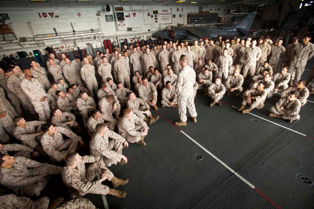 Colonel Scott D. Campbell, commanding officer, 15th Marine Expeditionary Unit, speaks to his Marines and sailors in the hanger bay of the USS Peleliu Nov. 1.  The 15th MEU is deployed as part of the Peleliu Amphibious Ready Group as a theater reserve and crisis response force throughout U.S. Central Command and the U.S. 5th Fleet area of responsibility.