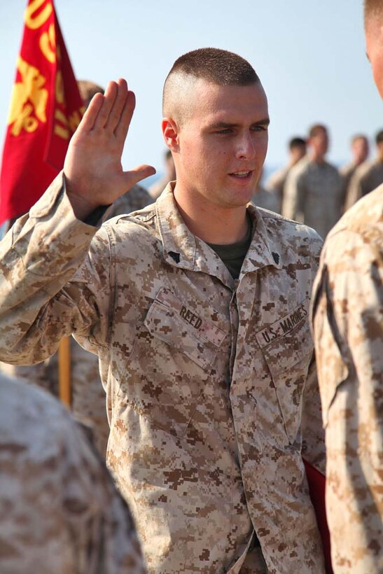 Corporal Robert Reed, ground radio repairman, Landing Assault Reconnaissance Platoon, Weapons Company, Battalion Landing Team 3/5, 15th Marine Expeditionary Unit, re-enlists into the Marine Corps aboard the USS Rushmore, Nov. 1. The 15th MEU is deployed with the Peleliu Amphibious Ready Group as a theater reserve and crisis response force throughout U.S. Central Command and the U.S. 5th Fleet area of responsibility.