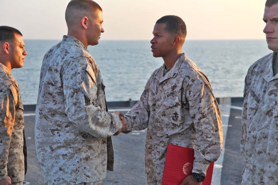 Lance Cpl. Matthew Constant, artillery mechanic, 1st Platoon, Battery B, Battalion Landing Team 3/5, 15th Marine Expeditionary Unit, is promoted from Pfc. during a promotion ceremony on the flight deck of the USS Rushmore, Nov. 1. The 15th MEU is deployed with the Peleliu Amphibious Ready Group as a theater reserve and crisis response force throughout U.S. Central Command and the U.S. 5th Fleet area of responsibility. Constant, 22, is from Brooklyn, N.Y.