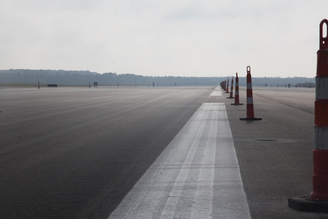 Cones line the center of runway 32L as the contractors put the finishing touches on the newly resurfaced runway on Cherry Point Oct. 26. This was the first runway to be worked on since the start of largest paving project aboard the air station since the last repaving project in 1998. The cost of this project when finished will be $10.39 million dollars, which is less than half the cost of an AV-8B Harrier. "People may think spending this amount of money on a runway is absurd and useless," said Mike D. Morgan, the construction manager for Cherry Point's facilities maintenance department.  "Think of it from this perspective, if we don't spend this money and we lose even a single Harrier we are losing more than $20 million dollars to buy a new one. With just one successful month of have a foreign object damage free landing space, this project pays for itself."