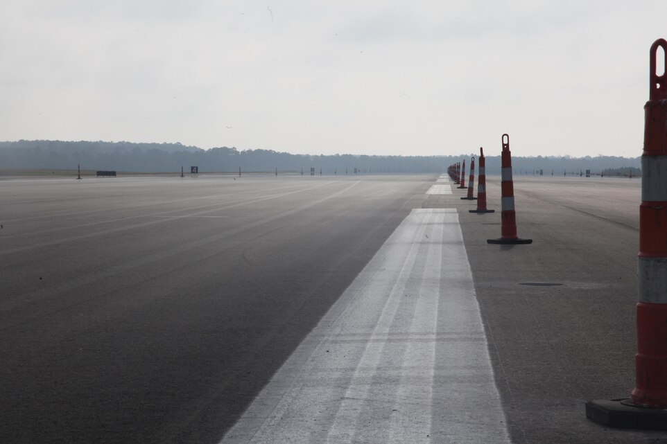Cones line the center of runway 32L as the contractors put the finishing touches on the newly resurfaced runway on Cherry Point Oct. 26. This was the first runway to be worked on since the start of largest paving project aboard the air station since the last repaving project in 1998. The cost of this project when finished will be $10.39 million dollars, which is less than half the cost of an AV-8B Harrier. "People may think spending this amount of money on a runway is absurd and useless," said Mike D. Morgan, the construction manager for Cherry Point's facilities maintenance department.  "Think of it from this perspective, if we don't spend this money and we lose even a single Harrier we are losing more than $20 million dollars to buy a new one. With just one successful month of have a foreign object damage free landing space, this project pays for itself."