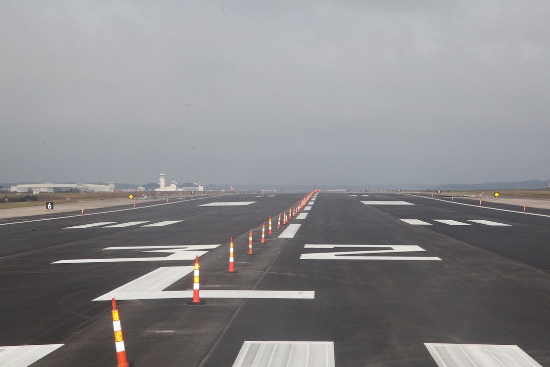 Cones line the center of runway 32L as the contractors put the finishing touches on the newly resurfaced runway on Cherry Point Oct. 26. This was the first runway to be worked on since the start of largest paving project aboard the air station since the last repaving project in 1998. The cost of this project when finished will be $10.39 million dollars, which is less than half the cost of an AV-8B Harrier. "People may think spending this amount of money on a runway is absurd and useless," said Mike D. Morgan, the construction manager for Cherry Point's facilities maintenance department.  "Think of it from this perspective, if we don't spend this money and we lose even a single Harrier we are losing more than $20 million dollars to buy a new one. With just one successful month of have a foreign object damage free landing space, this project pays for itself."