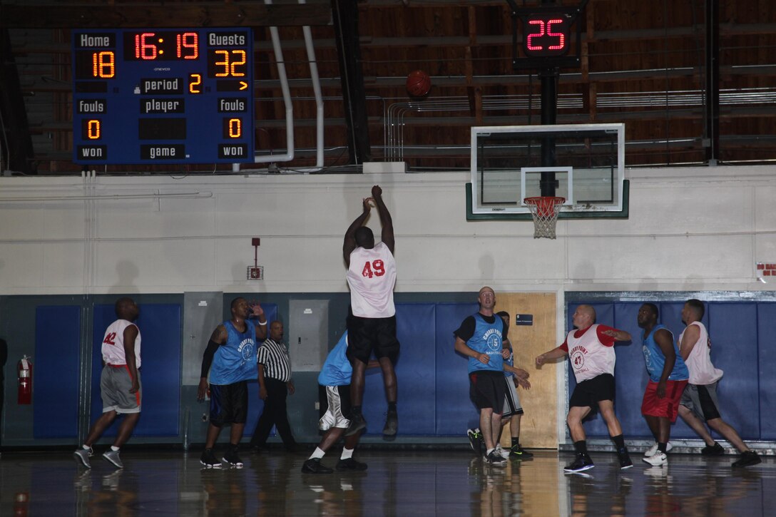 Spartans Shooting guard, Reginald Bell puts up a 3-point shot as players of both teams box-out for the rebound in the 11th game of the intramural basketball season inside the Marine Dome Oct. 29. Bell scored four points in the 58-50 loss to the Expendables.