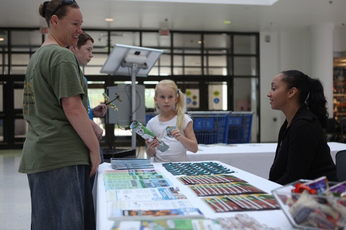 A family asks questions about different products displayed at the Energy Fair hosted at the Marine Corps Exchange aboard Marine Corps Base Camp Lejeune Oct 19. The fair was a venue to illustrate innovations currently on the installations and things people can expect to see in the future.