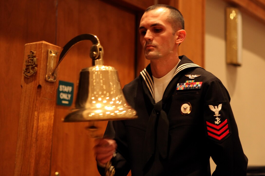 A sailor rings the ceremonial bell nine times while the birthday cake is brought to the front of the ceremony during the Navy Ball at the New Bern Convention Center in New Bern, N.C., Oct. 20. The Navy turned 237 this year, and sailors celebrated their birthday with a strong emphasis on the Navy’s role in the War of 1812.