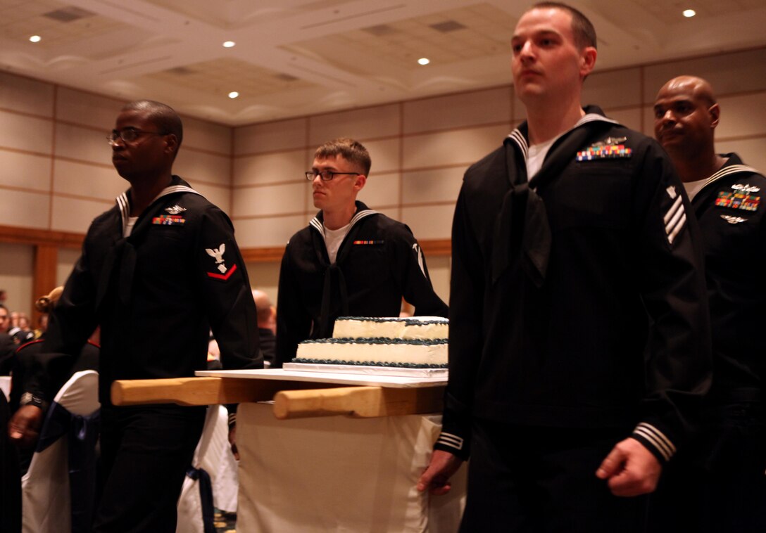 Members of the cake detail for the Navy Ball march the cake to the front of the room to be cut by the oldest and youngest sailor in attendance during the ceremony at the New Bern Convention Center in New Bern, N.C., Oct. 20. The Navy turned 237 this year, and sailors celebrated their birthday with a strong emphasis on the Navy’s role in the War of 1812.